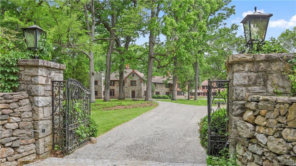 Dramatic & inspiring, this 1920's stone & brick Family Compound in Westport’s Premier Old Hill Estate Area neighborhood achieves the perfect balance of old world charm, intimacy, and opulence with distinctive custom millwork and modern expensive upgrades throughout. Tucked behind tall privacy stonewalls and iron gates on a beautifully manicured and professionally landscaped 3 acres w/heated gunite pool and tennis/sports court, 50 Sylvan Rd N is the epitome of fine living. Nearly 11,000sf which includes 6 bedrooms in the main house & 3 bdrms in the guest house wing over the pool cabana, you'll fall in love with the unrivaled personality & excitement at every turn: oversized public rooms with high ceilings; beams; 9 fireplaces; big windows & french doors; gourmet kitchen with cozy fireplace & French doors that open to the back patio and courtyard for al fresco dining; impressive master suite with soaring ceilings & sitting room w/fplc. Ideal for today's hybrid or work-from-home lifestyle, there are 2+ offices & 500sf+ above the 3-car garage. Other special features include pool cabana w/kitchenette, changing rooms, full bath & laundry; multiple patios for large scale entertaining; & tennis court/sports court with fun viewing party hut. Just minutes to shops, downtown, Westport’s delicious restaurants, gorgeous beaches, train & highways.