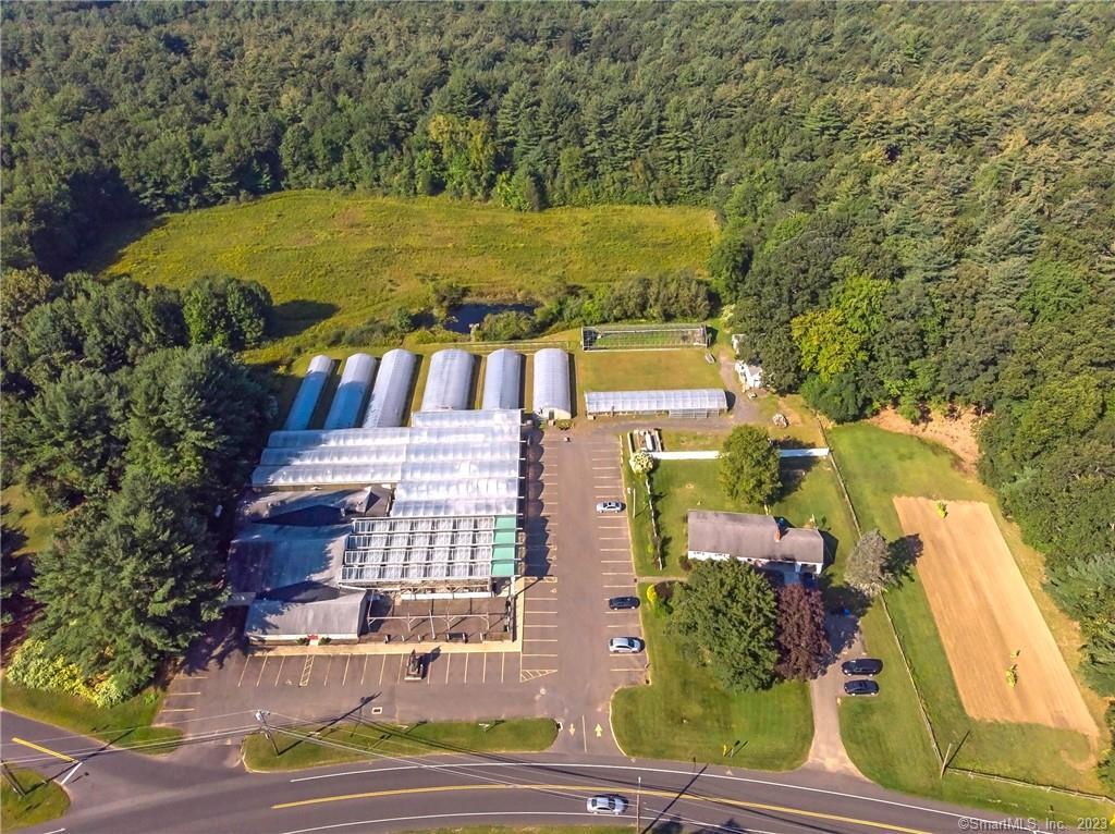 Turnkey Garden Center/Nursery with a single family house on one 11.8Ac parcel available for the first time. Previously an established Garden & Gift Shop Retail Center which was run for nearly 50 years. Located on busy Rt.140 with Avg 12,700 Traffic Count. Approx 5,200sqft of finished building space and 10 greenhouses including a significant atrium style greenhouse showroom in the front perfect for future retail. Three bedroom custom ranch with attached garage and central air is currently leased for $2,000/month (access granted to home only after serious interest). Large irrigation pond on the property between the greenhouses and the cleared back land. Other uses possible with town approval.