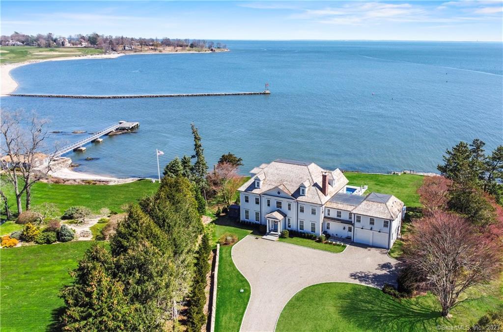 ONE OF THE SINGLE MOST MAGNIFICENT, PREMIER, AND CUSTOM WATERFRONT ESTATE ON THE EASTERN SHORELINE. HUGE PRICE REDUCTION SELLER IS NOW MOTIVATED. Private and gated entry welcome you to this coastal home that was honored and selected amongst all mansions nationally & highlighted on an episode of Fox Business Mansion Global for its brilliance & beauty. Set on a level 1 acre lot of direct waterfront with views of Southport Harbor & Long Island Sound. Spend your days watching the boating activity from the Harbor, wake up to amazing sunrises, sip coffee from your balcony & enjoy all that this resort-like lifestyle offers. Abundant natural sunlight throughout the first floor w/ a wall of glass doors that span the width of home that provide a landscape of breath taking and brilliant water views. This modern day floor plan spared no expense w/ custom high end finishes, lighting, window treatments, mill work, & impressive details. Three levels of living, 9000+ SF, 17 spacious Rooms, 6 full & 2 half Baths, 5 en-suite Bedrooms including the Primary w/ a Sitting Room, his/her walkin closets, & private Deck overlooking the water, 2 car Garage w/ 2 car lifts that services a total of 4 cars, 2000+SF unfinished lower level (not often found in water front homes) & whole house generator. The back yard features multiple Patios/Terraces & seating areas that surround your salt water Gunite pool w/ sparkling water views. Minutes to Southport Beach, Village, Harbor, Train & Library & 1 hour to NYC.