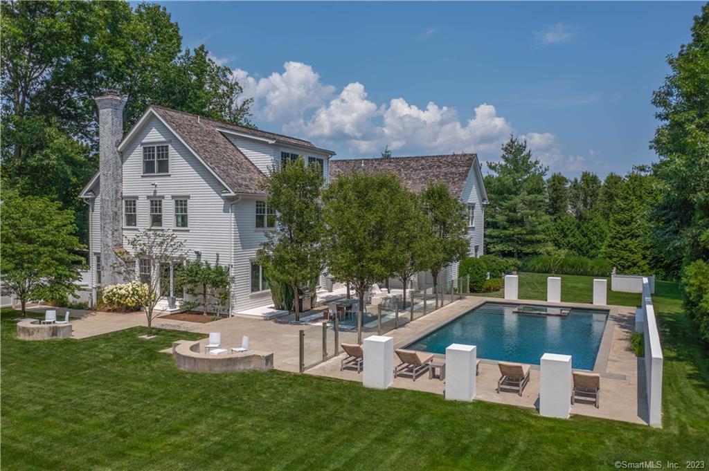 This stunning transitional colonial house, custom built in 2011 and substantially renovated in 2022, is privately situated on a flat, dry professionally landscaped acre of property in the Long Lots school district. Boasting 6 spacious bedrooms, 6 full and 2 half baths, and 4 levels of finished space, the possibilities are endless. Every detail of this custom built Able Construction home has been carefully designed and meticulously maintained. The chef's kitchen, recently renovated with Voytek custom cabinets and Caesar stone concrete countertops and island, opens graciously to an eat in area with double height ceiling and comfortable family room. Walls of windows provide exceptional natural light and the open floor plan allows for easy living. Built in wet bar in the formal living area makes this home an entertainers dream. Modern features abound. Complete with heated gunite pool and spa, no detail has been overlooked. Home gym, craft room, and game room on the lower level, bonus space and 6th bedroom on the 3rd floor, give the discerning buyer plenty of options and versatility. See addendum for recent upgrades.