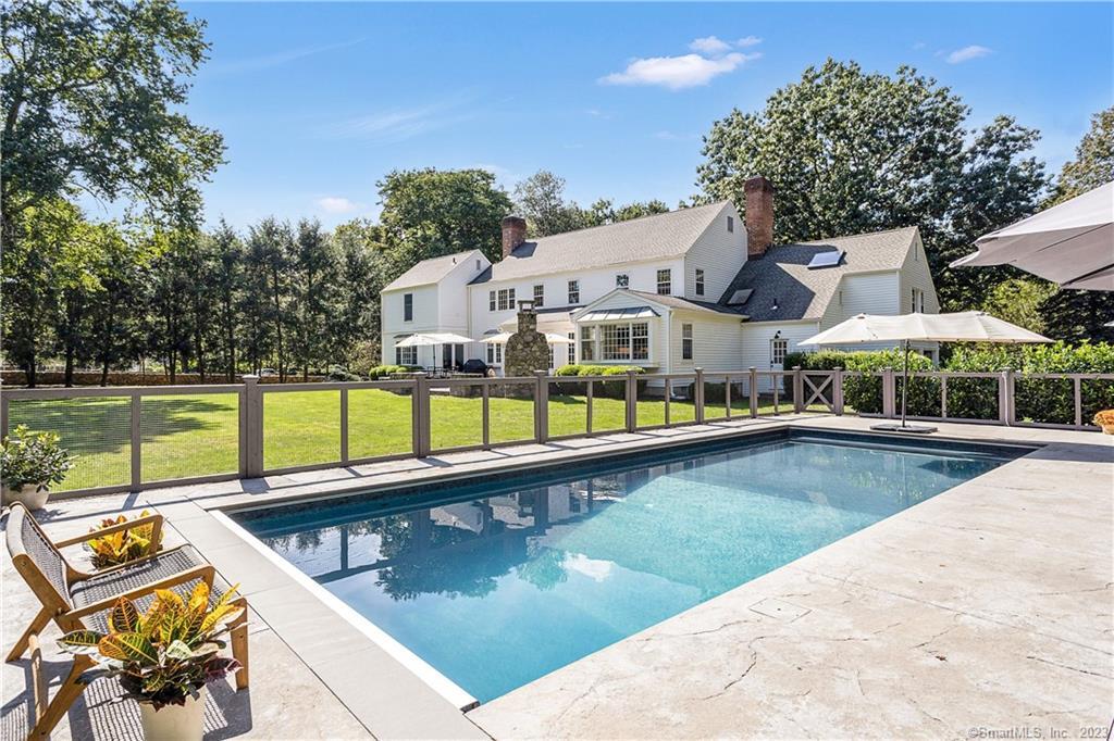 South Wilton Gem! Set back from the road with a grand approach and a welcoming circular driveway, this stately 5-bedroom, 4.5-bathroom Kellogg colonial epitomizes timeless beauty and modern luxury. The magnificent property features a newly added salt water in-ground pool with automated safety cover, embraced by expansive lawns, professional landscaping with mature trees, and stone walls. Step inside, and you'll immediately be embraced by an aura of serenity and charm. The heart of this home is a recently renovated gourmet kitchen with a large breakfast area, both bathed in natural light, seamlessly connecting to the flagstone patio complete with a native stone outdoor fireplace. A two-room guest/in-law suite with full bathroom and separate entrance is located off the front hall, allowing for comfortable hosting of visitors. Other rooms on the main floor include a welcoming living room and a family room, both graced with fireplaces, dining room with French doors to the patio, generously sized gym/recreational room, and expansive bonus room situated right off the kitchen area. Venturing upstairs, you will find a primary bedroom suite with an adjoining sitting room/office and two full bathrooms. Three specious bedrooms and a hall bath complete the upper floor layout. Beautifully maintained and cared for with numerous additional updates. All this plus award-winning schools and just minutes to nature trails, shopping, Metro-North, Merritt Parkway. Simply spectacular!