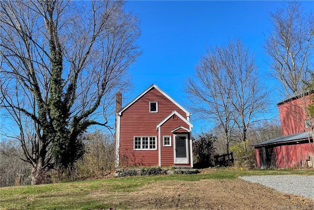 Charming and rustic cottage on estate property close to town. Cozy and comfortable, the house offers wood floors, stucco walls and beautiful exposed beams throughout. The living room and full bathroom occupy the main level. The kitchen with brick floor is in the walkout lower level. There is an island, electric stovetop, new wall oven, new dishwasher, and new refrigerator. All stainless appliances. The walk-out leads to the designated private outdoor space and includes brick patio, overlooks a meadow and has space for a garden. The one bedroom with vaulted ceiling is on the upper level and includes a large double deep closet. Washer and dryer are located in the nook under the stairs in the kitchen. Rental includes landcare, mowing, snow plowing and trash. Tenant is responsible for electric, cable, internet, propane (heat) and renter's insurance. Tenant take cares of shoveling from front door to driveway. One cat will be considered. There are low ceilings. Must have good credit. Barn is not included in the rental. Credit Score must be 700+.