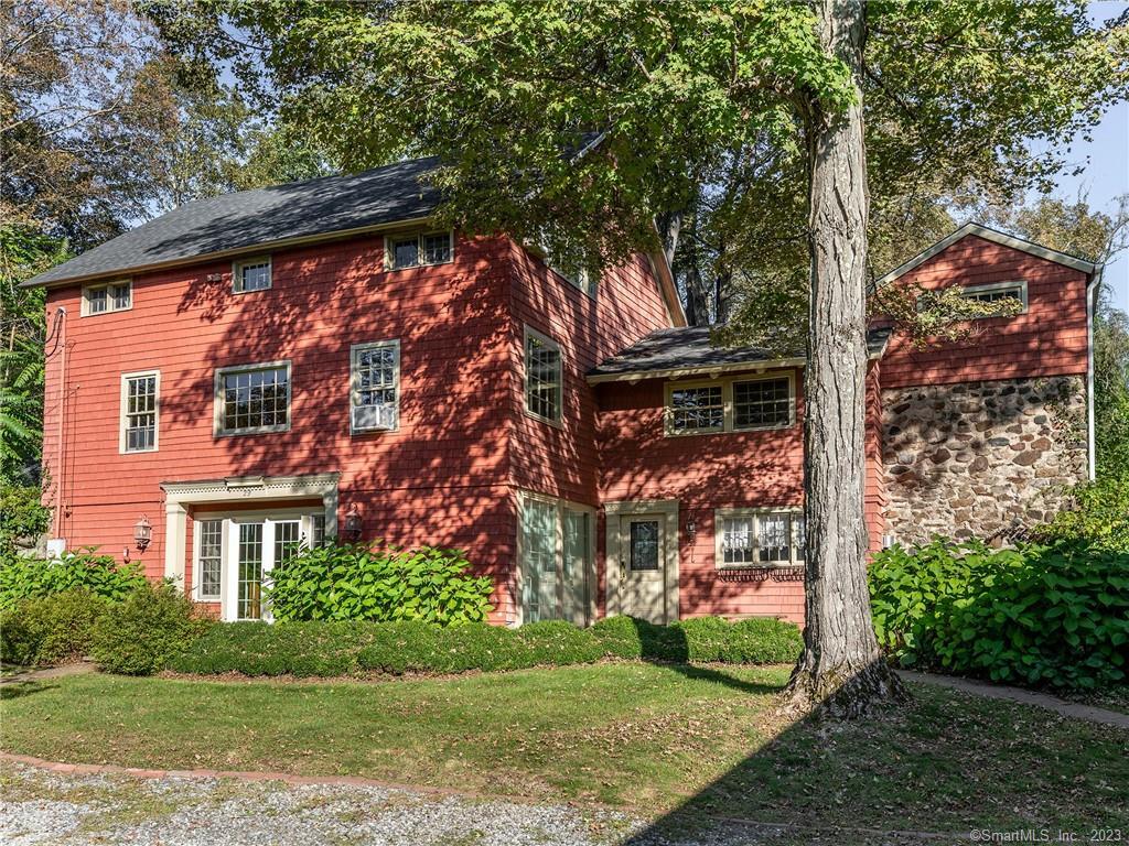 Unique Vintage Post and Barn home in the heart of Woodbury, the Antique Capitol of CT! 4 Bedroom and 3 full baths on 1.34+/- acres with a large detached barn/2 car garage. The house exudes charm with original touches throughout like hand-hewn wooden beams and wide plank floors that still show the 200-year-old carriage tracks. Use the pulleys to lower the staircase and climb to the top of the grain silo that has been converted into a sunny breakfast nook on top, and a hidden wine cellar on the bottom (fBookcase will open the secret door!).The main floor has an entertainer's kitchen with stainless steel appliances. It also has a casual dining room, large pantry, large living room, dining room, and main floor bedroom. Walk up to the top floor to find the main suite with a full bathroom including a jacuzzi tub. A 2nd bedroom with an en suite bath also has a charming built-in window seat.The walk-out basement has a large bedroom that can also be used as a playroom or theater space. The reading nook with built-in shelving and a cozy propane fireplace are just waiting to be filled with your books! The oversized 2-car garage features even more storage and room for a shop upstairs. Explore the nature of the 1.3-acre property that now includes footpaths, a fire pit, and a slide in the peacefully wooded side yard. Home was featured in the New York Times and Circa Houses' Instagram. New septic tank (2020), new well pump (2020), new hot water heater (2020) a recently redone roof.