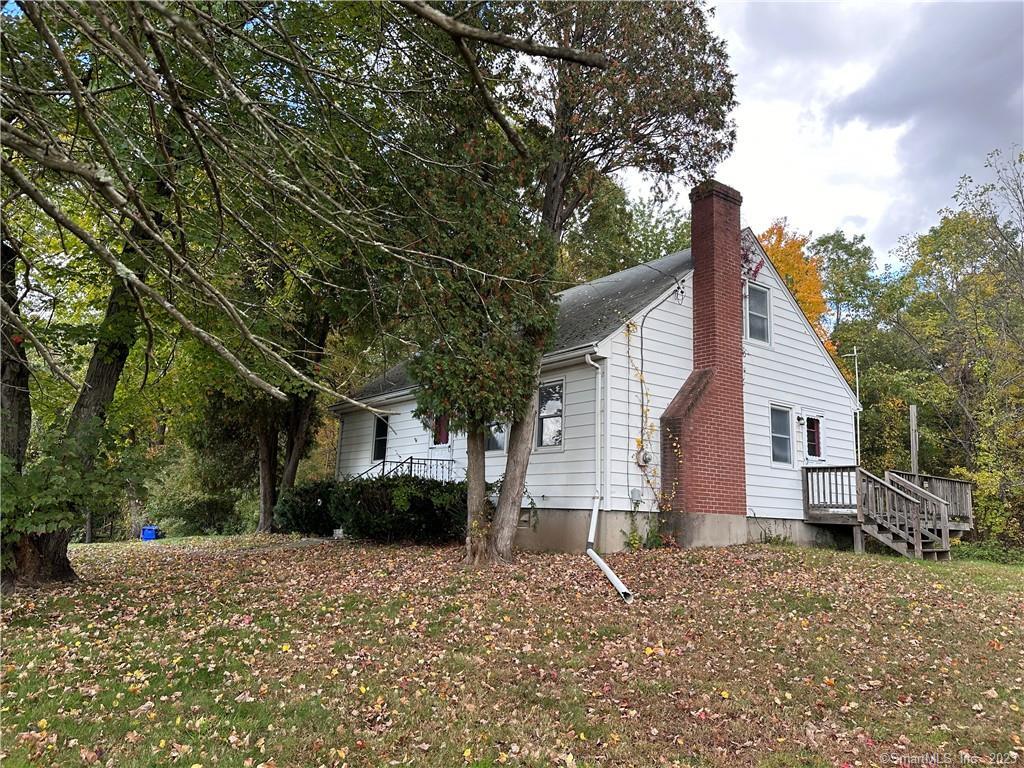 3 Bedroom Cape on a ONE ACRE lot. 1.5 baths, hardwood floors, and in a great location. Garage is underneath the house, newer driveway. Public sewer. Lots of possibilities! A little TLC is required and is to be sold "As-Is"