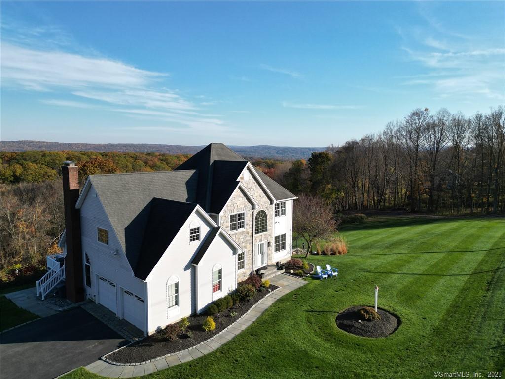 This impeccably maintained Colonial home, nestled in a coveted section of Woodbury showcases three levels of living space. Begin with a grand two-story foyer graced w/ marble flooring. The 1st level has a well-appointed office with custom built-ins, bright and spacious LR & DR that spans from front to back, and an open kitchen w/ granite counters, S.S appliances, a built-in wine cooler, and a dining area w/ natural light from windows and skylights. Adjacent to the kitchen, a sunken family room features fresh hardwood floors and an efficient new pellet stove. Beyond the dining area lies a deck with distant views and abundant privacy. The 2nd level reveals 3 generously proportioned bedrooms, including a primary suite spanning three rooms. The suite boasts Trey ceilings, Hickory floors, dual walk-in closets, a cozy sitting room, and a custom en suite bathroom with W-in closet and laundry. The 2nd 3rd bedrooms provide ample closet space and share a well appointed full bath. Descending to the lower level, a space exuding warmth and natural light extends the living area by over 900 sq. Ft. 11-foot ceilings, hickory flooring, a marble bath & steam shower, kitchen area with granite countertops, a charming built-in seating nook, and a Murphy bed for guests, this floor is an inviting retreat. French doors give access to a bluestone patio, a plunge pool, and a meticulously manicured yard. Irrigation, Generator, and surround sound complete this home. 90 min to NYC and 30 min to train.