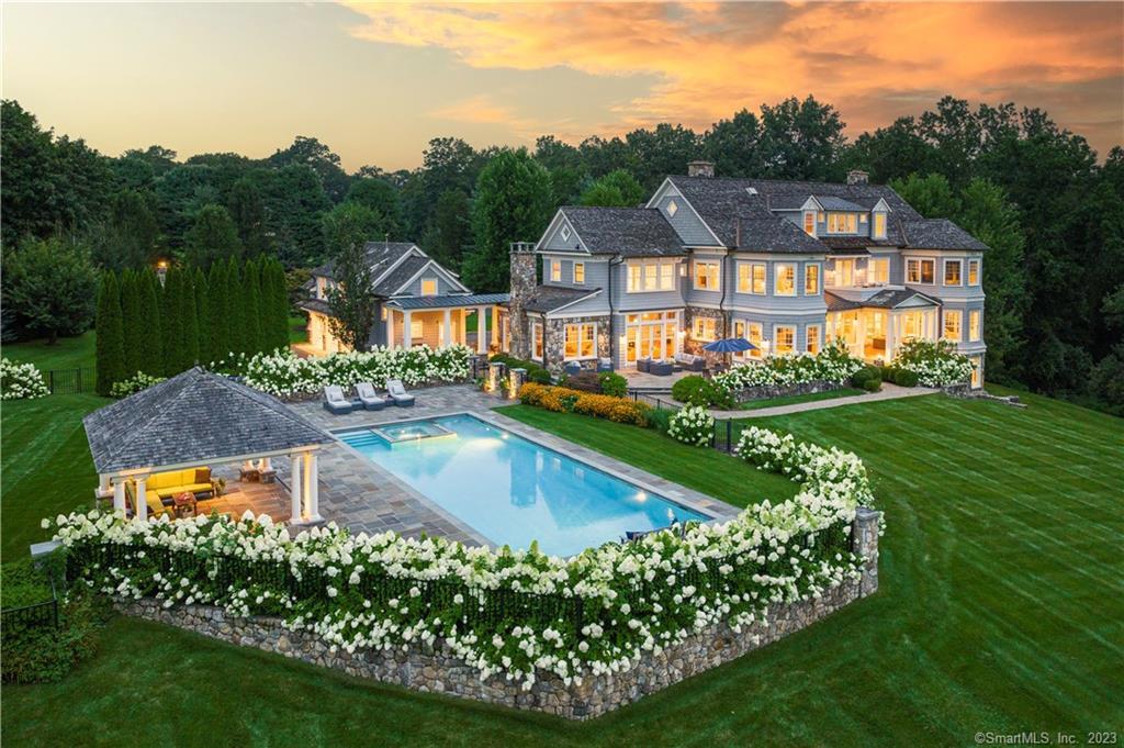 Welcome to 785 Oenoke Ridge in the picturesque town of New Canaan, CT. A stone-pillared entrance and private drive leads you to this magnificent estate minutes from New Canaan's vibrant town center. Expertly crafted by award-winning team Gardiner & Larson and sited on 4.32 pristine acres, the more than 13, 000 square foot home offers a luxurious and private retreat for the most discerning buyer. With four finished levels, the home boasts the finest quality craftsmanship and meticulous attention to detail. The double living room creates an elegant and inviting space, perfect for entertaining guests. The chef's kitchen is a culinary masterpiece, and with its high ceilings and abundance of oversized windows the home is flooded with natural light, seamlessly blending the indoors with the surrounding nature. The primary suite is a sanctuary of its own, featuring dual bathrooms and dressing rooms, sitting room and exercise room. The six bedrooms in the main house are all ensuite and the finished walk-out lower level features 10' ceilings. A separate 900 sq/ft 2-room suite with bath over the garage is ideal for guests or au pair. The stunning oversized pool with sunken spa is the perfect place to unwind and a custom Dalton Pavilion offers a shaded retreat. Mature rows of evergreens and flowering Limelight hydrangeas add a touch of elegance and privacy to the landscape. With its premier location among New Canaan's finest estates, this home truly embodies the epitome of luxury living.