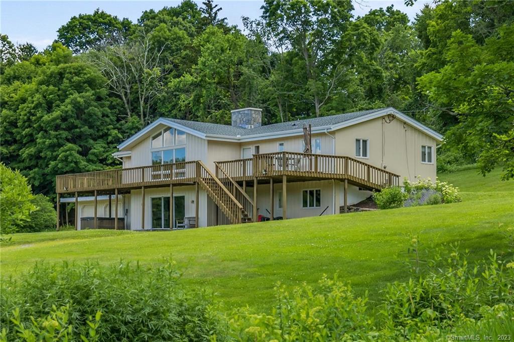 This remodeled contemporary is located in the pastoral Grassy Hill section of Woodbury. The property features a large yard and additional open meadow space, allowing for great country views to be enjoyed from the expansive deck. A recently renovated main level consists of an open floor plan, highlighted by the oversized stone fireplace. The sunken living room has hardwood floors and a large projector screen for relaxation time. The kitchen features vaulted ceilings, soapstone counters, a chic natural stone slate floor, and access to the back deck and grill. Beautiful views are to be had from the master bedroom with hardwood floors, walk in closet, and a completely remodeled master bathroom. The opposite end of the home consists of two bedrooms and an additional full bath. Downstairs is a large open room for additional living space, a third full bath, and a smaller room which could be used for an at home office setup. Just 5 minutes to Main Street in Woodbury, and under 2 hours to Manhattan. Available Jan 1- Oct 1 at $4, 000 per month. Full Year at $4, 500 per month.