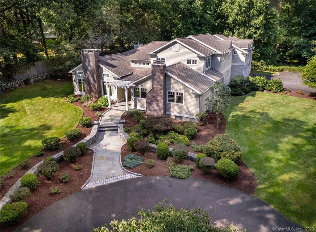 This meticulously maintained architect custom designed 5-bedroom modern colonial was extensively renovated and expanded in 2004. A true gem tucked away in a peaceful serene setting offers privacy and tranquility. The covered stone entry welcomes you into the grand two-story foyer, you enter the open living room and dining room with high ceilings which add a sense of grandeur and spaciousness to the living areas. The gourmet kitchen with dining area, high end appliances and oversized island opens to a spacious family room with vaulted ceiling and fireplace. Step outside where you can relax on the screened porch or stone patio and enjoy the beautiful and private outdoor living space. The comfortable first floor primary suite situated away from living areas, has a cozy fireplace and full bath. Plus 2 more bedrooms and two full baths. The second floor offers 2 nice sized bedrooms each with large walk-in closets, office and magnificent bonus room! Enormous amounts of closets and storage throughout the house, plus an oversized 3 car garage, landscaped gardens all minutes to downtown Westport, train, schools, shopping and beaches!