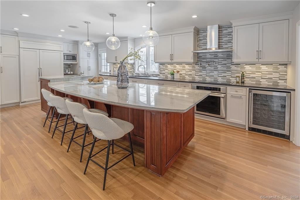 An exquisite home tailored for the luxury home buyer. This Colonial is nestled on a serene cul-de-sac, occupying a private 1+acre lot. Spanning 2,507sq.ft. across the main levels & 807sq.ft. in the LL. The heart of this residence is its culinary haven, boasting a spacious 6-seat quartz countertop island overlooking the family room. Equipped w/top-tier SS appliances, incl. an Induction Cooktop, 2 ovens & warmer drawer, Sub-Zero Fridge & wine fridge. Entertaining is effortlessly elevated w/a built-in speaker system in kitchen, Family room, living room & back patio, which is accessible from the kitchen & DR. Making indoor/outdoor living seamless & the perfect entertainment space. If that weren’t enough, the family room & kitchen boast heated floors, creating a cozy & inviting atmosphere year-round. Enjoy the cozy formal LR in front of the wood burning fireplace. The spacious primary BR offers a luxurious en-suite bath, featuring radiant heated floors, a shower w/radiant heated floors & a walk-in closet. Rounding out the 2nd floor are 3 more spacious BRs & a full bath. Additional amenities incl. a full house generator, Smart Home controls, steam humidifier throughout the home, invisible dog fence, Central A/C & heated 2-car garage. Beyond the amenities, the property enjoys the serenity of a quiet street while being conveniently located near shopping, restaurants & entertainment, access to I-95, the Merritt & Metro North. Enjoy Westport beaches & it’s various parks year-round.