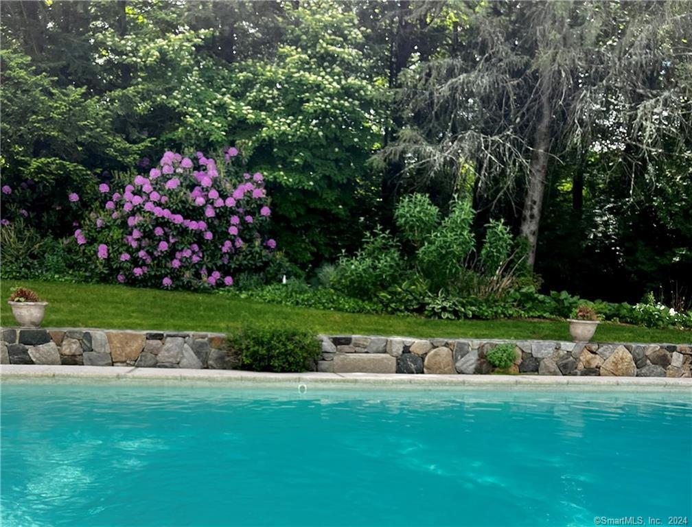 This is a furnished summer rental available from 7/27/24 - 8/25/23. It can also be available for 7/12 - 7/26 for an additional $10, 000. Enjoy the summer in beautiful Wilton, CT in this exceptional 5 bedroom home with oversized swimming pool. And a brand new sauna! Great location! 2 beautifully landscaped acres close to town, train, shops, beaches and great restaurants. Plenty of room to stretch out in almost 5000 SF, including 3 TV/Lounging Rooms and 2 Work from Home Offices. Extensive outdoor area for dining, entertaining, relaxing by the pool, with an outdoor kitchen and gas fire pit. Extensive lawns for games, exercise and recreation. Full gym in lower level, with a SoulCycle bike. Several large screen TVs. Tesla charging station in garage.