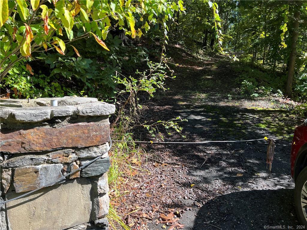 3.48 acre lot with access rights to Lake Lillinonah and privately located. The top of the lot is level. Building is a remnant of the land's prior use and may be used for storage while you build your home. Lake access is within a short walking distance and deeded egress and ingress allowed by an easement that is shared with other property owners. Come with your builder, your plans and make this gorgeous land your own. Maps and easement information is contained in supplements.