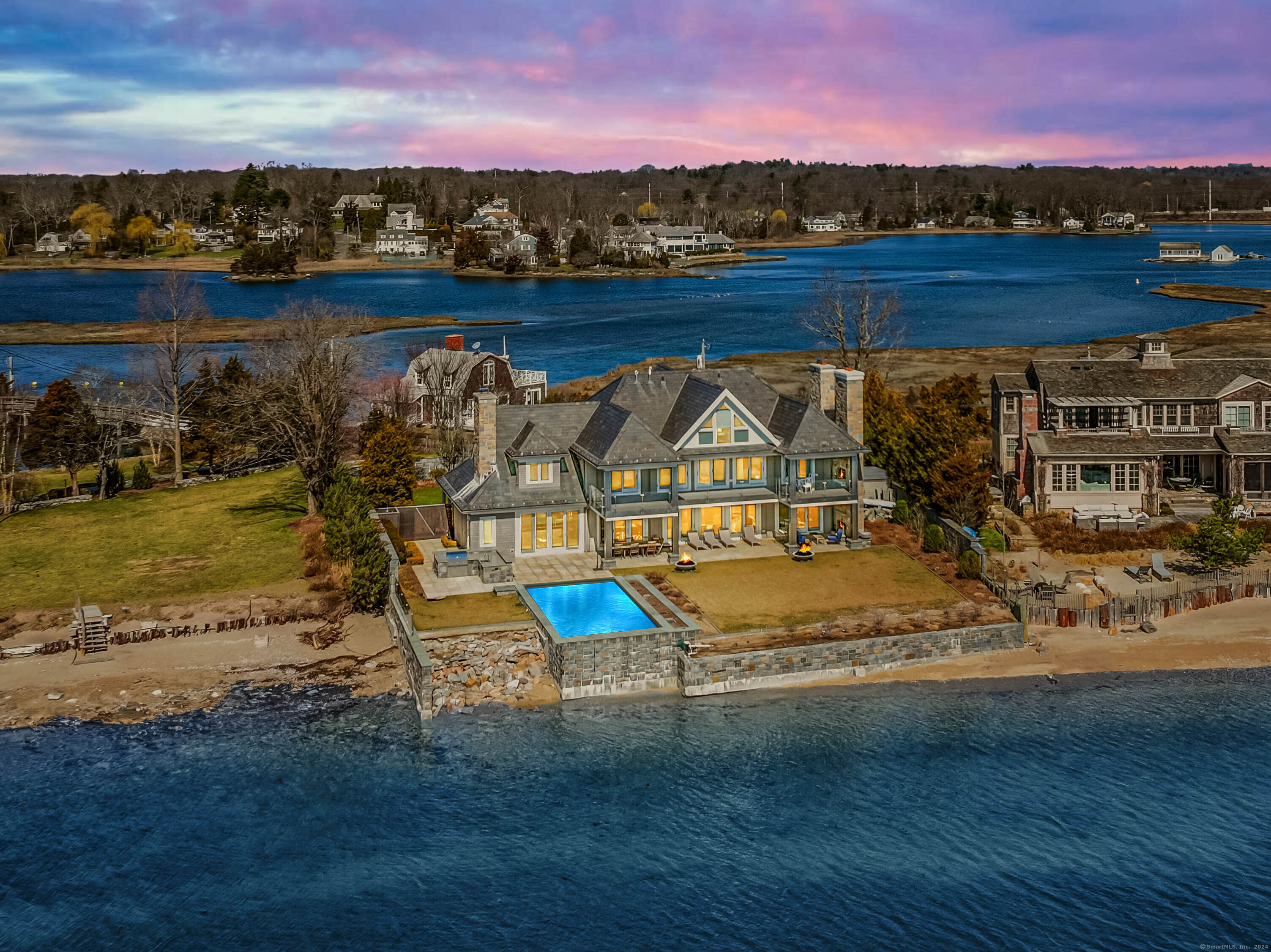 PRIVATE WATERFRONT PARADISE! Tranquil location offers unrivaled access to Panoramic Ocean views of Long Island Sound. A short walk across the Wooden Footbridge w/ Sherwood Mill Pond on your left and LI Sound on your right leads to the gated private Island of Compo Mill Cove & a handful of unique waterfront homes. The property itself has been customized from top to bottom w/ exceptional thought & detail. Only house on the Cove w/ a secure, storm surge concrete wall. Featuring over 3950 sq ft of living space, 5 beds, 5.2 baths, an open floor plan w/ wall to wall windows that offer 180 degree views of the ocean from every room. First fl features a living room w/ fireplace, family room, beautifully appointed wet bar, dining area, & gourmet kitchen w/ exclusive granite, Viking appliances, modern design, & a first fl bedroom w/ ensuite bath. Upstairs offers 3 additional bedrooms including a primary w/ a fireplace, private balcony w/ outdoor fireplace, & bathroom w/ sauna shower, tub, & double vanity. The highest quality materials were used in every corner of the home, from beautiful marble to custom imported Italian sici tiles, to state of the art electronic & digital components that can be used from within the home or remotely no detail was overlooked. Outdoors is equally as impressive w/ an infinity pool, outdoor kitchen, shower, bathroom, terrace w/ fireplace, lush gardens, fountains & impeccable landscaping that sit behind a gated, secure stone wall border. Just 1 hr from NYC!