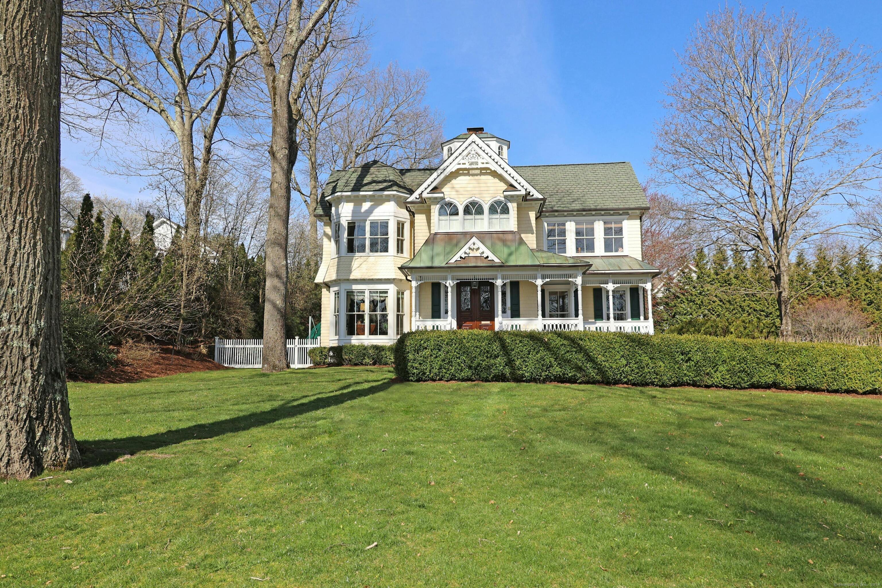 This stunning custom-built Victorian home is in a prime location, built by a renowned Westport builder. It boasts classic elegance and custom craftsmanship, with 9-foot ceilings and intricate carpentry moldings and architectural details all throughout. The kitchen is a dream for entertainers, opening up to a spacious family room with a cozy fireplace. The primary suite is a luxurious retreat, with two walk-in closets and its own gas fireplace. Additionally, the second floor offers three more en-suite bedrooms. The finished lower level offers a second laundry, office, half bath, and family room, all with plenty of storage space. Outside, a private patio with a built-in kitchen and grill area, as well as a pond with a waterfall, provides the perfect space for relaxation and entertaining guests. The two-car heated garage offers high ceilings and room for a lift.