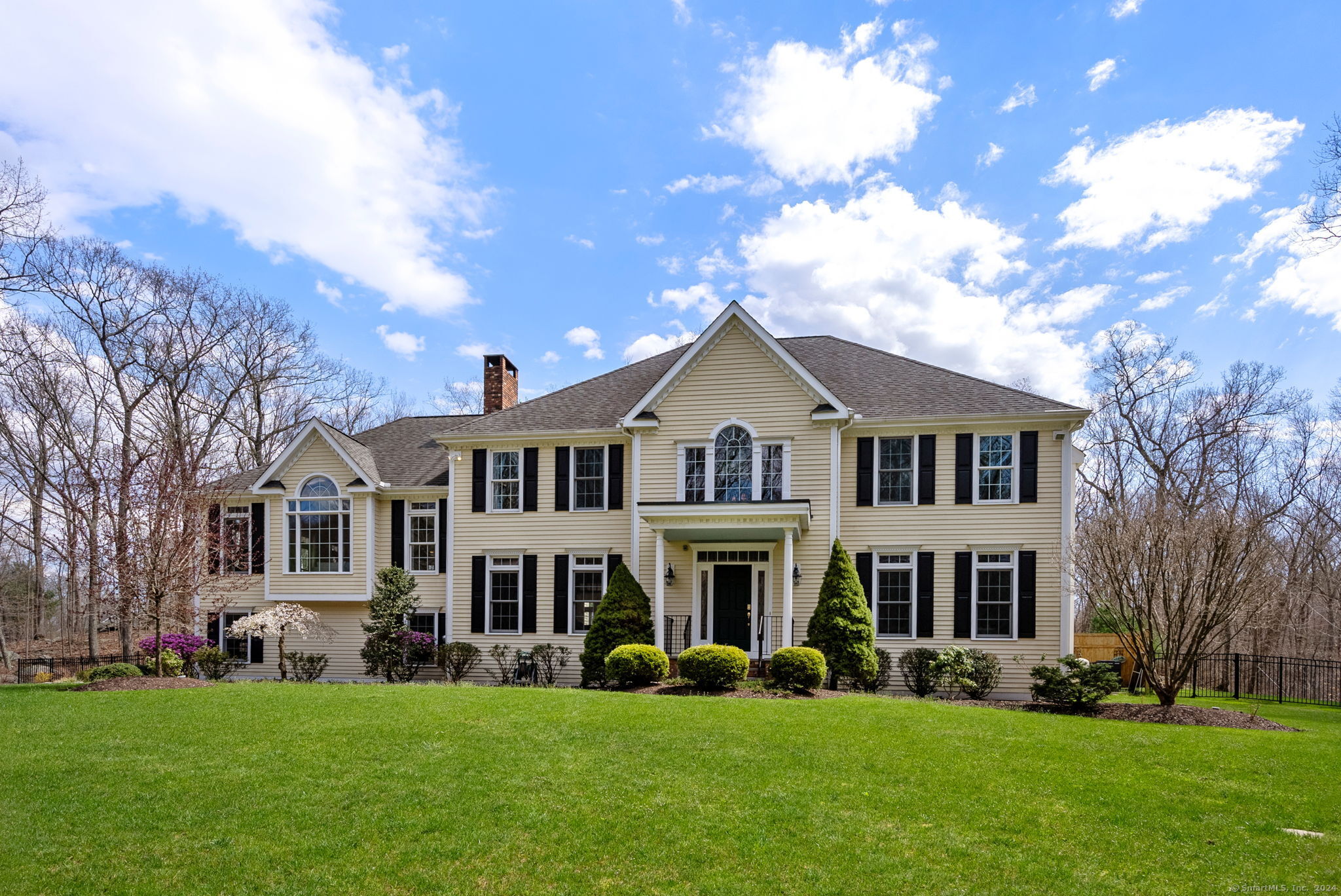 Welcome to this elegant custom colonial home, nestled on 3 acres of beautifully landscaped grounds, offering unparalleled privacy and tranquility. This home has it all, 4 bedrooms, over 4,000 sq ft, a layout for today's discerning homebuyers, move-in ready, custom mill work, rich hardwood floors throughout and a 20x40 salt water in-ground pool. A two-story foyer is flanked with a sophisticated living room w/ gas fireplace. The formal dining room w/ tray ceiling connects seamlessly to the kitchen boasting white cabinetry, island, gas cooktop, premium appliances, a dining area and slider to the backyard retreat. A grand sun-soaked family room with Palladian windows, a gorgeous stone fireplace gives way to a sunroom w/ 3 walls of windows, ideal for a home office or creative space. The upper level houses a fabulous primary bedroom w/ gas fireplace, walk-in closet and spa-like bathroom w/ double sink, jetted tub and spacious shower. Three addt'l well-appointed bedrooms with abundant closet space, one ensuite and a shared hallway bath w/ double sink. Addt'l features are main floor office and laundry room, freshly interior painted, new boiler, underground utilities, generator hookup, 3 car garage, irrigation system and full deep basement w/ easy expansion. The backyard oasis showcasing a saltwater pool, electronic solar cover, waterfall feature, and slide set this home apart. It's complete with a fully fenced-in backyard w/ a fire pit, large patio, and an outdoor shower! A must see!