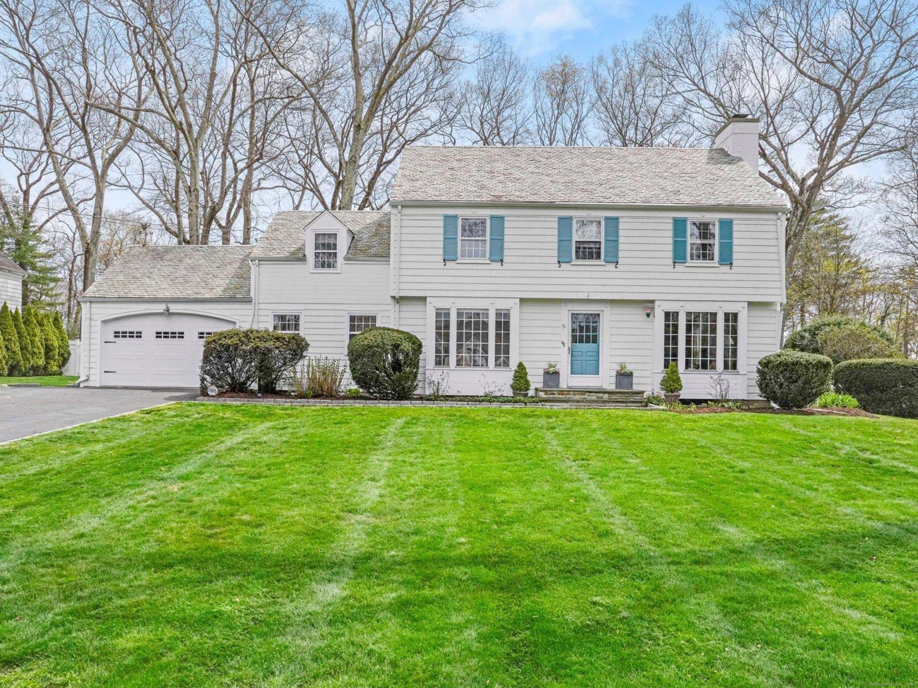 Fabulous Center Hall Colonial with remarkable curb appeal on one of Fairfield's prettiest streets. This 1939 charmer boasts fresh updates, hardwood floors, custom millwork, and oversized windows providing natural light throughout. The gracious room scale and terrific flow make this house feel - and live - much larger than its 2,743 sq.ft. A lush property with sparkling in-ground Gunite pool add up to a dreamy lifestyle at 51 Stoneleigh.  The inviting interiors begin with a welcoming foyer flanked by formal dining room and front-to-back living room with fireplace - both with large box bay windows. Bright eat-in kitchen serves up new Quartz countertops, stainless steel appliances, pantry, center island and glass door to a large deck providing an easy entertaining flow whether grilling, al fresco dining, wine by the fire pit, or s'mores at the outdoor stone fireplace.  The spacious family room has a large fireplace, built-in bar and floor-to-ceiling bay window overlooking the park-like property. The adjacent cheerful sun room leads to the fenced-in pool area and lovely pool house with 1/2 bath and kitchenette, bordered by perennial gardens.  Upstairs the primary suite accommodates a king-size bed, closets galore and window seat. Primary bath with radiant heat floors, double sinks, shower stall and a balcony overlooking the scenic backyard. Three more sunny bedrooms and tasteful hallway bathroom complete the second floor. A second staircase leads to one of the bedrooms,