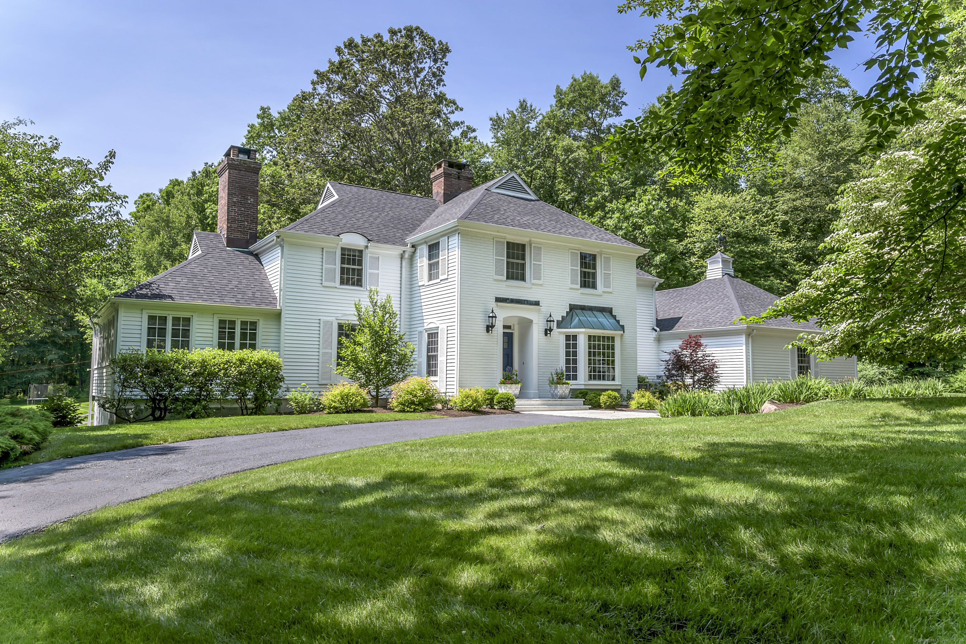 Exceptional turn-key Colonial in sought after SW Ridgefield on the Westchester border. Sophistication at everyturn! No expense spared in creating an exquisite transitional design w/high-end finishes throughout - HW Flooring, inviting fireplaces, designer wall-coverings and lighting, etc. Wonderful main level showcases: Living/Dining Rm w/FP, Family Rm complete w/wet bar & Large FP + French doors leading to a versatile Office/Sunroom/Playroom with site lines to the stunning property. The ultra custom eat-in KIT equipped w/professional-grade appliances is a Chef's dream. Laundry Rm, Mudrm & 2 Baths complete the Main level. Upstairs, the luxurious Primary Suite boasts His/Her's marble Baths with radiant heated floors, & large walk-in closet. 3 additional BR's plus 2 Renovated Full Baths and a fantastic, NEW sun-filled Home Office. Spacious, Lower Level offers a recreational space w/sliding glass doors leading to a Gym, Half Bath, and a convenient Pool Changing Room for easy access to the heated Gunite pool and spa amidst the professionally landscaped yard w/a babbling brook. The Barn provides a third Garage Space plus storage + countless options for additional living, entertaining space. Bordering numerous acres of Open Space provides added privacy. Natural stone outcroppings & mature trees create the perfect, private retreat. Whole-house generator. Minutes to Ridgefield's vibrant downtown - CT's #1 Cultural District! Approx 1 HR to NYC and quick drive to Metro North Trains.