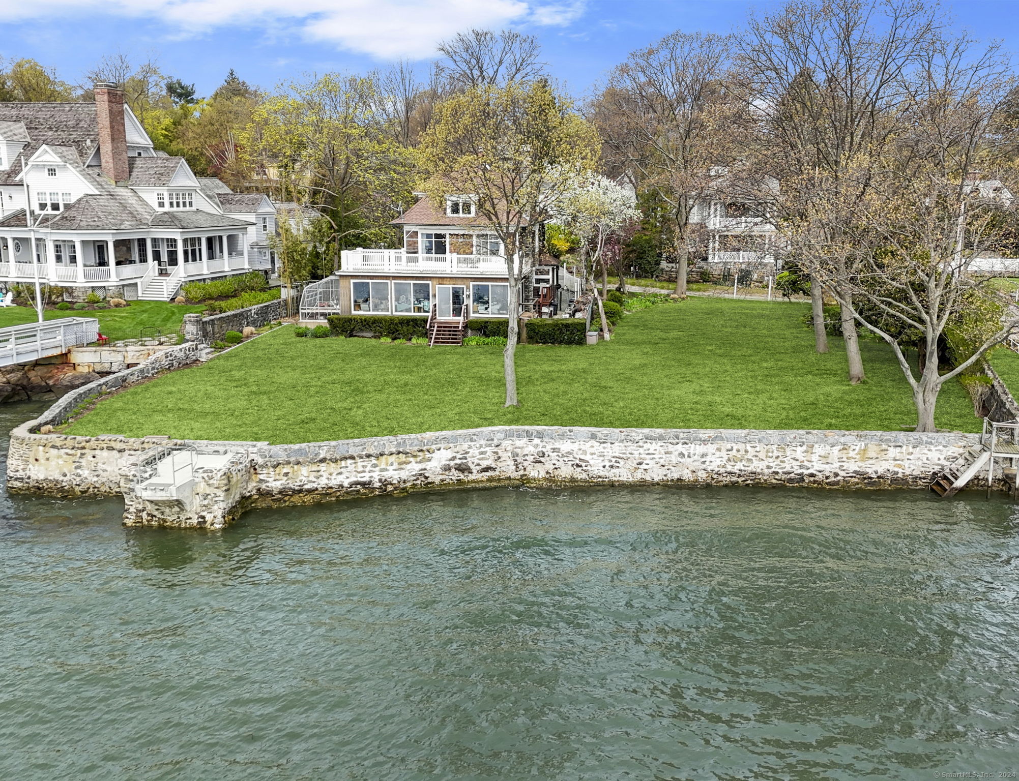 Experience tranquil waterfront living in Greenwich with sprawling vistas of Long Island Sound right outside your door. Offered for the first time on market in over 100 years, this expansive double lot spanning 0.7309 acres presents an ideal canvas for renovation or new construction, offering up to 10,028 sq/ft of FAR. Enjoy breathtaking views from your private dock or the current six-bedroom house. Conveniently located near Byram Park, residents can access the public pool, beach, marina, and boat launch. With close proximity to downtown Greenwich and Manhattan, this property seamlessly combines serenity with accessibility. Please note, the total FAR encompasses this listing combined with 0 Byram Dock Street.