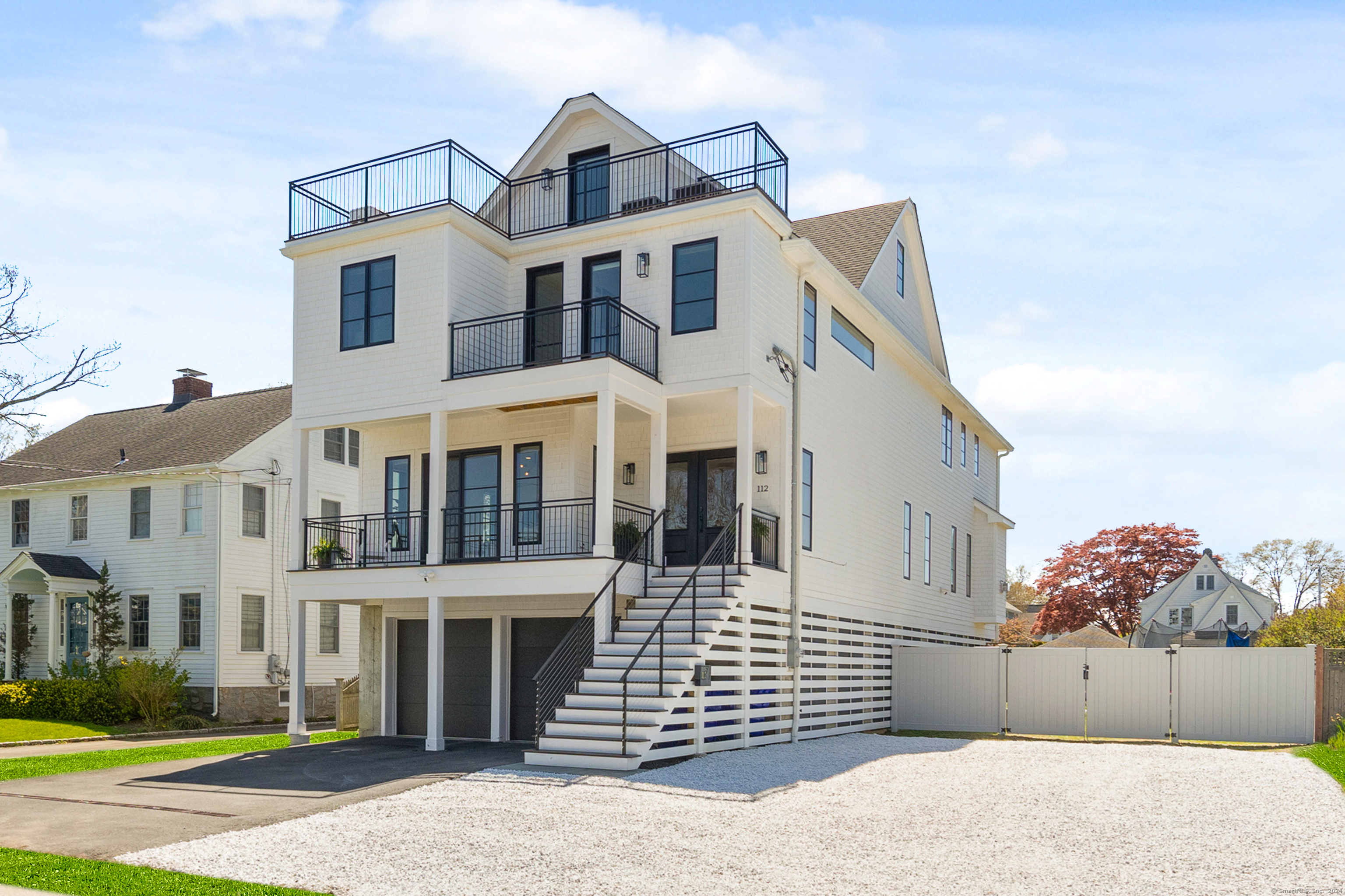 Step into the epitome of luxury coastal living in this architecturally stunning, sun-flooded California contemporary home set on oversized 1/4 acre dry lot in the heart of FFLD Beach--steps from town & Penfield Beach. This 5/6 BR beach haven boasts unmatched quality w/sensational glass railing staircase & hallways, 9-ft ceilings, 5" white oak floors throughout 3 floors & an abundance of oversized windows, glass doors & decks that bring the outdoors in. Central to this breathtaking home is the chef's dream kitchen, equipped w/a spectacular 10 ft waterfall quartz island, 48" paneled SUB-ZERO refrigerator, 48" Wolf double oven stove, walk-in pantry & custom wet bar w/sink & beverage fridge. Front porch, gorgeous formal living room, large dining room, casual breakfast area & family room w/gas fireplace & back deck create a seamless, airy 1st fl. flow. Upstairs, 5 BR including primary suite w/soaring vaulted ceilings, huge deck & sublime, spa-like bath w/enormous marble shower & radiant heated floors. 4 add'l generously sized BR, 2 BA & laundry room w/cabinetry complete the 2nd level. 3rd level w/full bath & deck w/soaring views offers endless possibilities for playroom, 6th BR, gym, office or combination. Lower level loggia overlooks huge lot w/endless possibilities & pool permit in place. Oversized garage, GENERAC FULL home generator, outdoor shower, gas/sewer. This is your chance to live your best life at the BEACH!