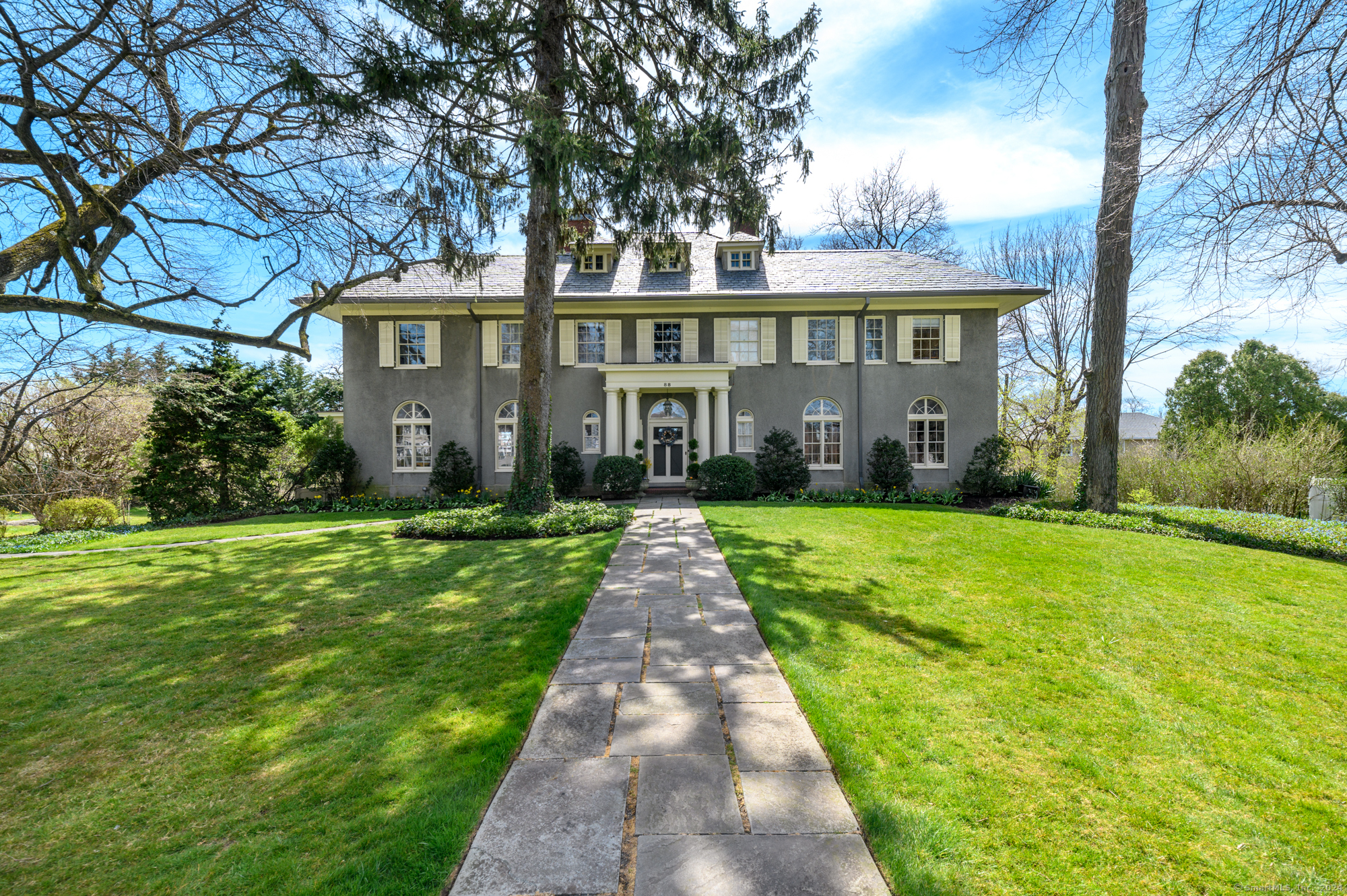 This is a rare opportunity to own one of the original grand homes of Shippan Point in Stamford, CT. This stately 7-bedroom Georgian colonial is located near the tip of the peninsula and has a magical soul. The drive to this impressive property will bring you back in time. It features an original wood staircase that spirals from the first floor to the third floor. The house has a slate roof, 3 fireplaces, and is on nearly an acre of flat land. The first floor has impressive Palladian windows throughout and has breathtaking water views from all three levels. The peace and tranquility of this prestigious property are beyond compare. Walk out through french doors on the first level onto a fairytale covered porch and gaze out through majestic columns to a vista of the Long Island Sound. The living room and dining room both have fireplaces and are perfect for entertaining. The primary bedroom has a fireplace, full bath, and french doors that lead out to a magnificent balcony with views of Long Island and Greenwich. This gracious home has ten-foot ceilings, yet it is still warm and intimate and might just be the perfect home for you. The basement has an additional 800 square feet of finished heated living space plus storage and walk out to manicured backyard. Close to train station, vibrant downtown Stamford, 3 public beaches and Chelsea Piers. Please note the number on the house is 88.