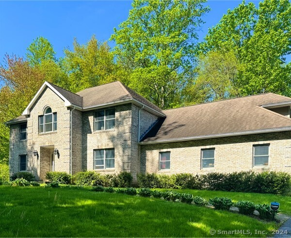 Discover this stately colonial residence, where classic charm meets modern comfort on a stunning 2.65-acre estate. With over 5, 000 square feet of exquisitely finished space, this impressive home features 5 generously sized bedrooms + 3 additional rooms that are sure to impress. Step into the luminous foyer and feel immediately at home. The inviting living room boasts a crackling fireplace and gleaming hardwood floors, perfect for cozy gatherings. A serene first-floor bedroom offers comfort and versatility, while two additional rooms provide limitless potential for customization. The heart of this home is its expansive kitchen, complete with tile flooring, upgraded black stainless steel appliances, and granite countertops. Ample space for a farm-style table makes this kitchen ideal for family meals and entertaining. Ascend the grand staircase to the upper level, where four beautifully appointed bedrooms await. The primary suite is a retreat with an ensuite bath, spacious walk-in closet, tranquil sitting room, and private balcony. The newly completed lower level presents limitless opportunities, featuring a full bathroom, a multi-purpose exercise/bonus area, and two versatile rooms, inviting you to indulge in moments of relaxation or recreation. With all-new central air, carpeting, fresh paint, lighting, hot-water heater, and a state-of-the-art irrigation system, this home offers unparalleled space and comfort. Don't let this opportunity slip away - schedule your viewing today