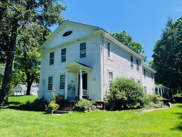 Situated in the heart of the Historic Village District of South Glastonbury, with it's variety of amenities, including shops, restaurants, churches, a post office, civic buildings, Roaring Brook, the oldest continuously operating ferry across the Connecticut River, and the oldest cider mill in the area. One of the notable properties within this historic district is this Greek Revival home dating back to the 1820s. This well-preserved home boasts federal features that add to its charm and character, including a portico with a coved ceiling, corner balusters, and an elliptical window. With 14 spacious rooms and 3 1/2 baths, this home provides ample space for large families or those who enjoy entertaining. The property also features a newly renovated gourmet eat-in kitchen, perfect for culinary enthusiasts and those who love to gather and entertain. Additionally, car enthusiasts will be delighted by the large barn on the property, providing ample space for vehicle storage or hobbyist activities. This historic home offers a unique opportunity to own a piece of South Glastonbury's rich history while enjoying modern amenities and comforts. Whether you are seeking a family residence with character and charm or a historic property with potential for restoration and preservation, this Greek Revival home presents an exceptional opportunity.