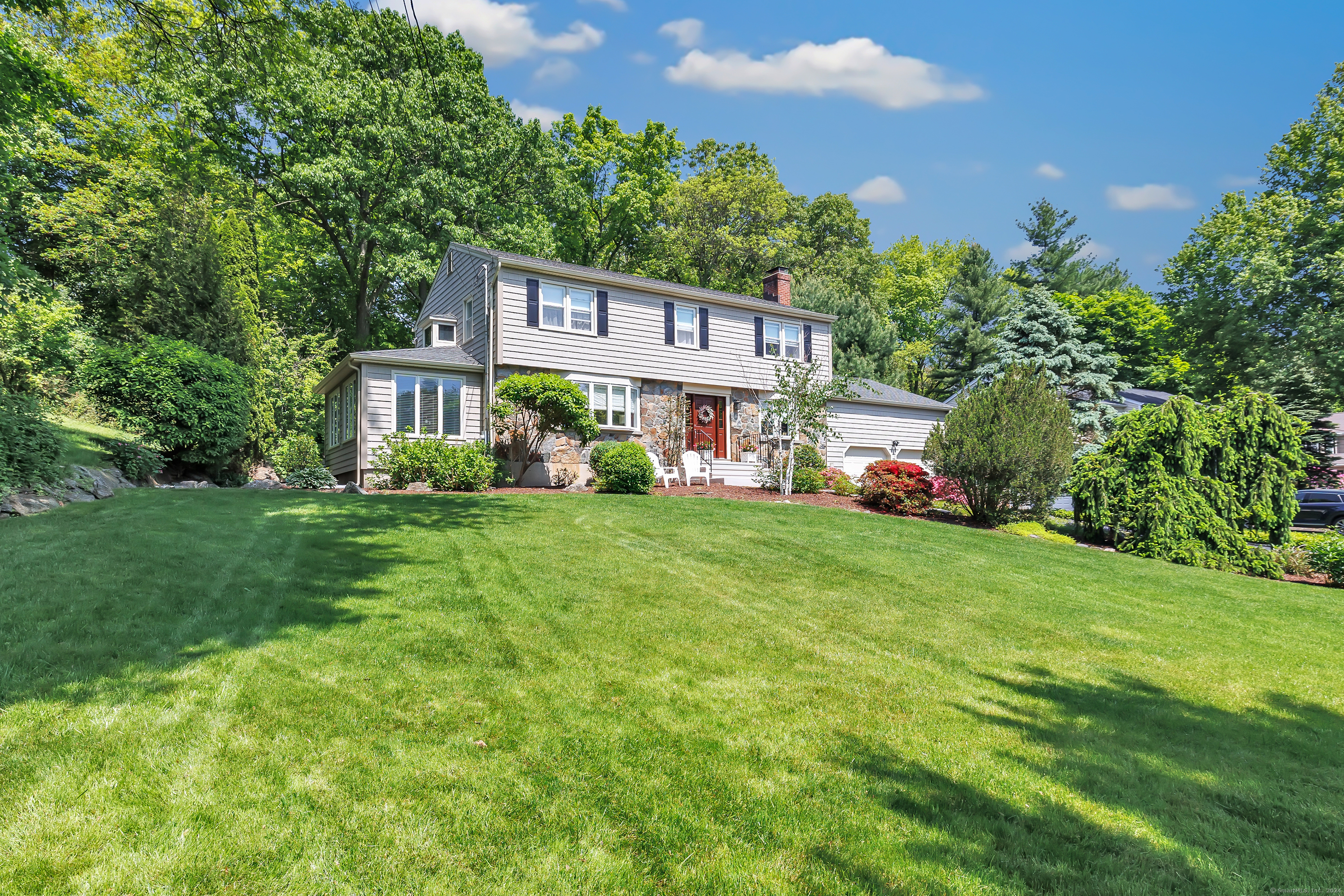 Located on a sought-after tree-lined street in Fairfield's Lake Mohegan neighborhood, this classic Colonial exudes warmth and charm both inside and out. The professionally landscaped yard & charming facade gives this home tons of curb appeal. Through the front door, you are greeted by a sun-filled living room that opens right into the gourmet EIK. This chef's dream has plenty of storage, SS appliances, shaker-style cabinets, quartz countertops, & an oversized island. The open concept living creates the perfect place to entertain. Just off the living room is a bonus space that can be used as a formal dining room or office. The front-to-back family room has a stone fireplace, crown molding, built-ins, and sliders to the screened-in porch. The screened-in porch will easily become your favorite room in the house! The tranquility & beautiful views make it the perfect place to unwind at the end of the day. The 2nd floor is home to the primary suite that is full of natural light, has a walk-in closet & updated full bathroom. 3 addt'l bedrooms & a chic hallway bathroom finish the 2nd floor. Step outside to your backyard oasis, complete w/a two-tiered deck leading you to the lush backyard w/mature trees & greenery. This picture-perfect neighborhood with annual block parties is close to Lake Mohegan where you can enjoy swimming, the splash pad & hiking trails. Minutes to schools, amazing restaurants, parks, beaches, golf courses, & more. Enjoy lake life year-round at 316 Canterbury La