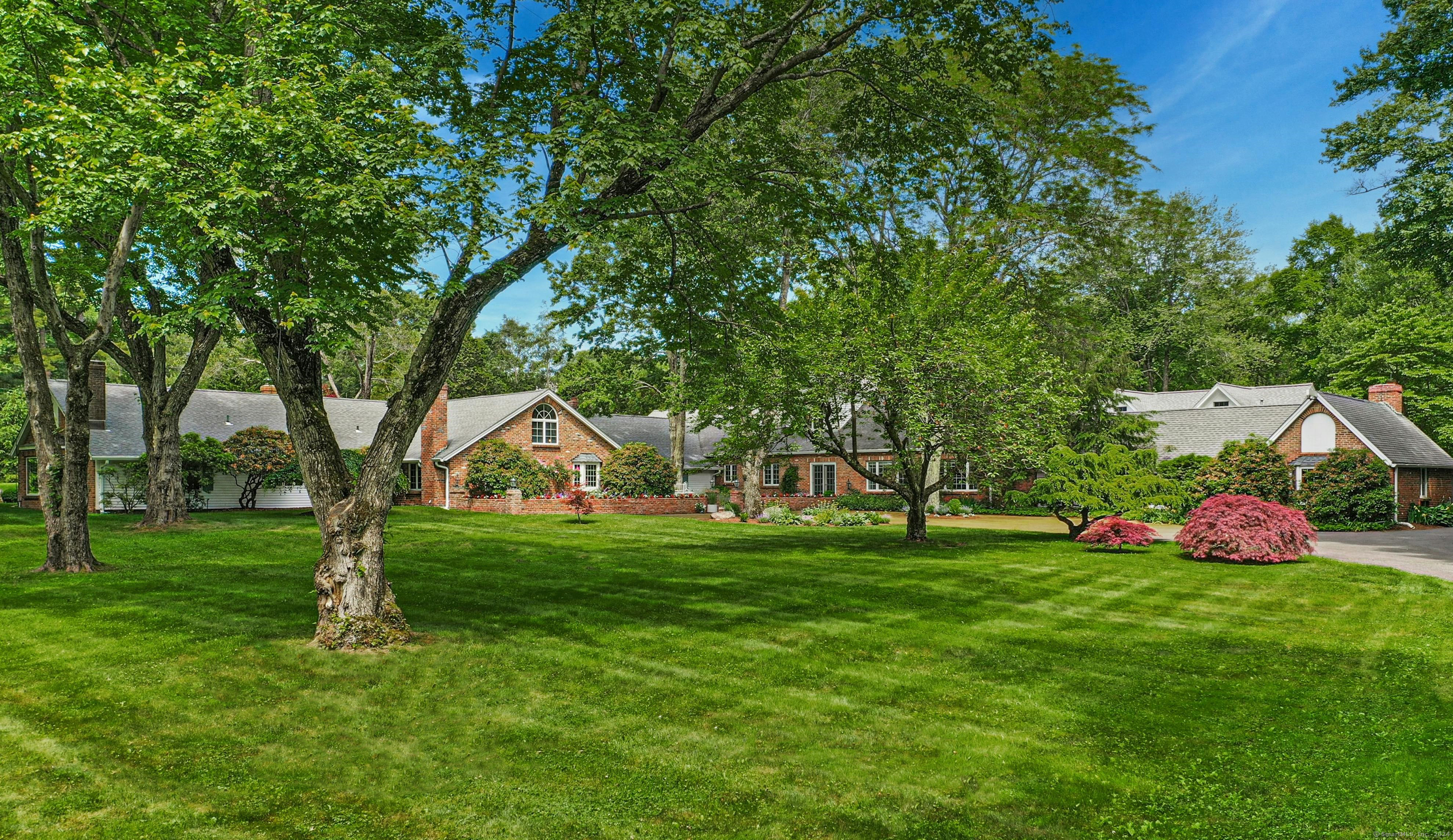 Come experience this handsome English manor house. A gracious family home and entertainer's dream at 8572 SF with multiple oversized entertaining areas. Marvel at the 28 by 30-foot grand living room with coffered ceilings and double doors that lead out to the gardens. Gather with family and friends near one of the six fireplaces. The dining room glistens with attractive molding and built in cabinets. Your spirits will soar as you enter the sun-drenched kitchen with your own vegetable garden just outside. Vaulted ceilings throughout will impress your guests. Unwind in the handsome and light filled billiards room complete a wood burning stove. The unique L shaped floor plan grounds a central hub of entertaining spaces with two separate wings for sleeping and productivity. On one side, a two-bedroom master suite and office sit while four additional bedrooms, two home offices and an oversized three-car garage sit on the other side of the layout. Now step outside and start to appreciate 7.5 sprawling acres. Thoughtful and mature landscaping graces every corner of this pastoral oasis. Stroll past the tennis court and koi pond to arrive at the European style pool house with 3595 SF of living space. The indoor pool glows surrounded by sliding glass doors on all sides and features a state-of-the-art jet propulsion system for lap swimming. Relax spa-style in this dreamy space.