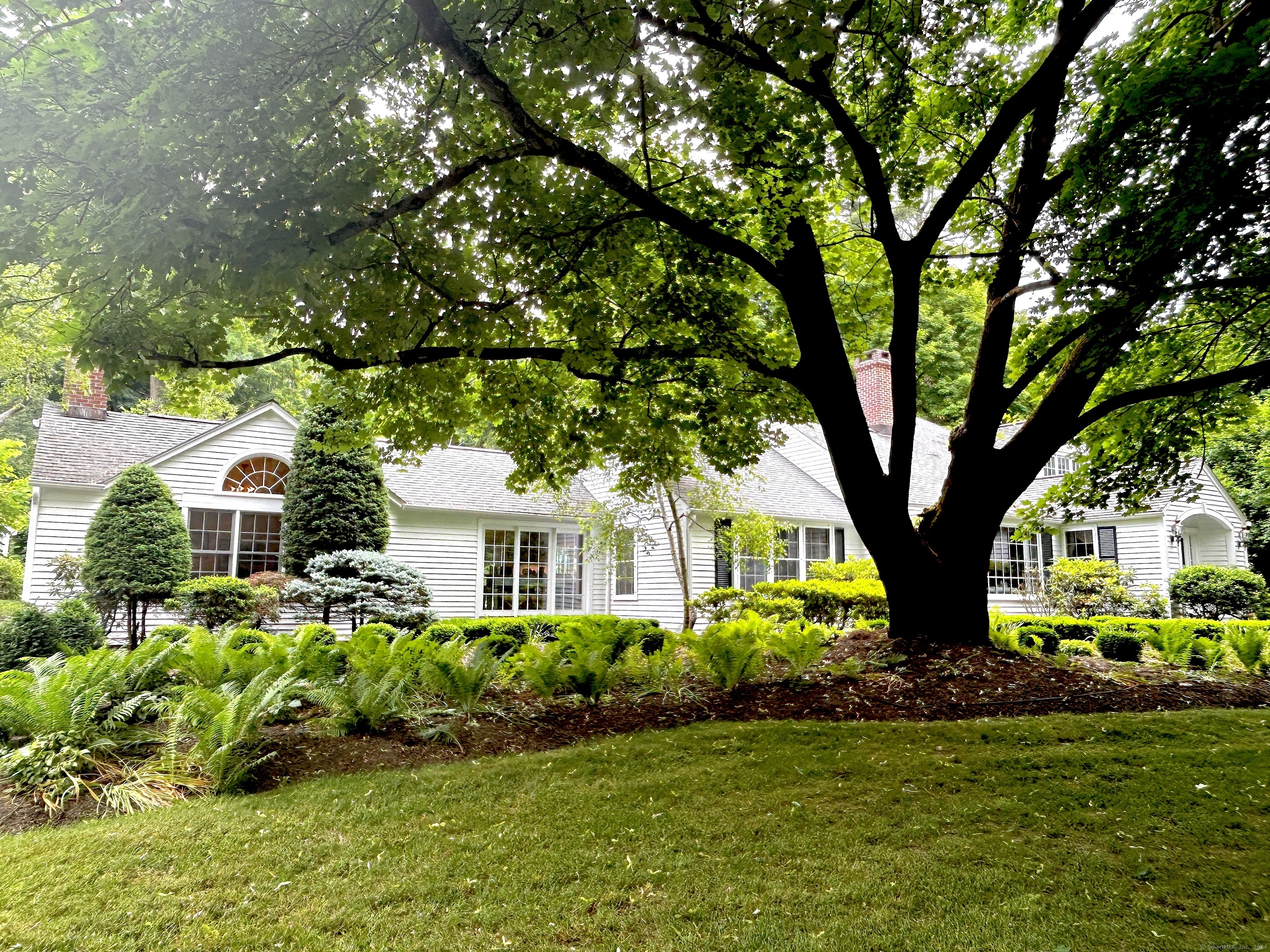 SPLENDID VINTAGE CAPE:No expense was spared in this modern revival of a classic, 1940's expanded cape and enchanting property. Its grandeur is enhanced by the intimate setting; nearly 3 acres of beautifully landscaped mature gardens designed to create separate environments for the gunite pool /patio area, cottage with bedroom, bath, living room, kitchen and the stone patio at the rear of the house, yet another richly designed private space. All is framed by ever-blooming specimen plants and evergreen trees that can be viewed from every room. The gracious primary suite; with a grand bath overlooking the glorious gardens, BR with fireplace, adjacent screen porch and richly paneled library completes a private wing with all the romantic flair of a 5-star country resort. A warmly inviting country, eat-in-kitchen with Smallbone cabinets, high-end appliances and fixtures, opens to a two-story family room with fireplace and French doors to access back and front yards/patios. The charming, original section of the home has a living room with fireplace and dining room on the main floor., 3 bedrooms 7 1.5 baths on the second floor, playroom in the basement and spacious laundry room on the main floor with mudroom access completes the main living areas. Hidden in the landscape, amid the most impressive estates of New England, in the heart of Sharon, Ct.this Currier and Ives picture perfect property, is a delight to the senses.