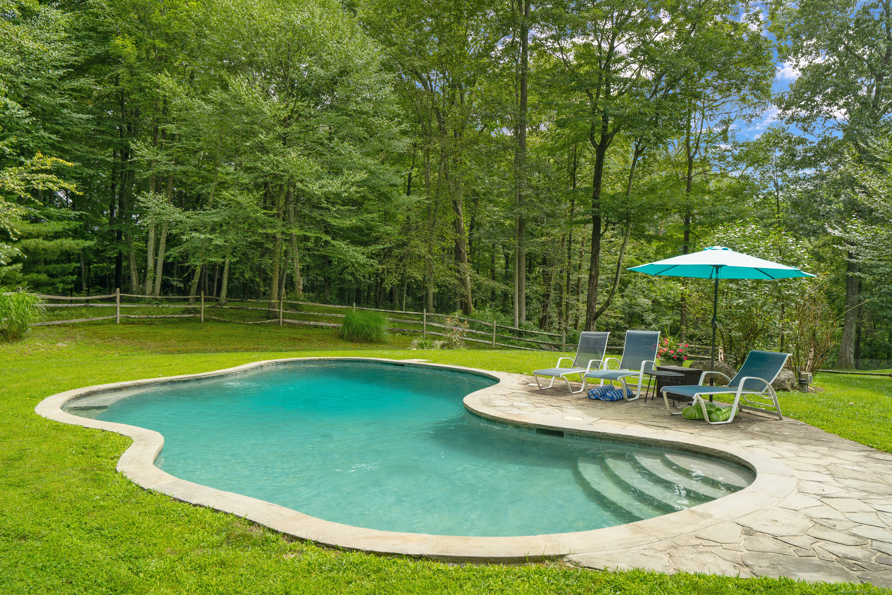 Don't sweat it! Just jump right in to your Gunite pool and relax by the pool in your private yard bordering open space. Fabulous expanded contemporary with wood floors, two fireplaces, oversized deck and three car garage. Gourmet kitchen with Wolf range with griddle and grill, Sub-zero frig and plenty of cabinetry. The Primary bedroom offers a wall of closets and spa-like bath with soaking tub. All bedrooms are spacious and one has a wall of bookshelves. The lower level family room has built-ins and a fireplace. House is equipped with a 22kw whole house generator. New front roof in June 2024. Town card lists 3 Bedrooms with office which can be used as 4th bedroom (1250 septic) The property is fully fenced and ready for new owners. Come take a look!