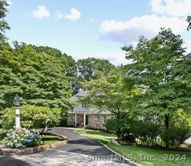 Welcome to 321 Frogtown Lane, a pristine stone and shingle Colonial home nestled on 2 acres in a private cul-de-sac, just minutes away from the Village of New Canaan. This 6-bedroom, 4.5-bath residence with Guest Quarters is ideal for a family eager to enjoy the quality of life and amenities New Canaan has to offer. The home has been completely updated and meticulously maintained, featuring wood floors throughout. The upper level boasts 5 spacious bedrooms, including the master suite with a luxury bath, fireplace, and walk-in closet. A second bedroom also offers a full bath, fireplace, and walk-in closet. The large, eat-in chef's kitchen is outfitted with brand-new, top-of-the-line appliances, perfect for daily dining and entertaining guests. Special features include a sunroom with a 9-foot ceiling and expansive windows providing a view of the wooded back lot and pond. The completely finished lower level offers versatile space for a home office, gym, guest accommodation, or an in-law suite. Lower-level doors open to a walk-out terrace and an inviting pool patio, ideal for entertaining or quiet relaxation. A backyard path leads to a peaceful pond, enhancing the serene setting. The residence also offers ample parking with a circular front drive and a 3-car attached garage. At 321 Frogtown Lane, enjoy privacy and serenity with the convenience of being less than half a mile from shopping, restaurants, parks, and recreation facilities in the center of the village.