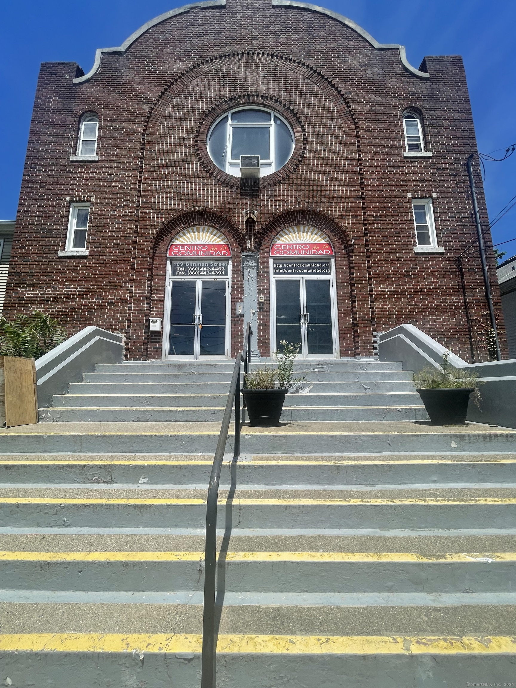 This large commercial space provides an opportunity for potential ideas such as: dance studio, fitness location, community center, church, offices, training & development, educational programs, etc.  The building is located west of New London's main business district, on the north side of Blinman Street between Truman and Bank Streets. It is a two-story masonry building, built out of red brick mostly laid in Flemish bond. Its entry has double doors separated by an engaged column, set in round-arch openings. A large circular window stands above the doors, within a large brick archway that encompasses it and the doors. Four small windows flank this arch, two on each side. The facade is crowned by a stepped segmental arch with short flanking posts. The interior has a vestibule area, with stairs leading up to a former gallery (now offices), with the main sanctuary including what appears to be an original chandelier.