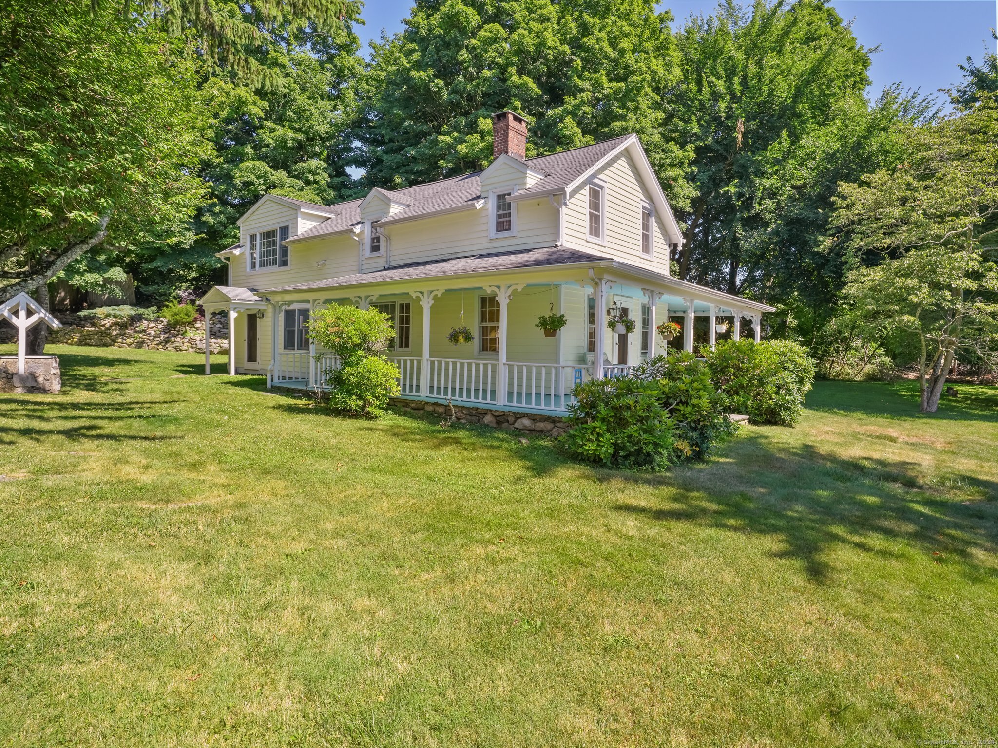 Step into history with this charming antique colonial, built in 1856 and nestled on .78-acre lot in the heart of Westport.  Picture-perfect moments await on the inviting wrap-around porch, adorned with exquisite wood trim detail, where you can enjoy the surroundings any time of the day. As you enter, the home welcomes you with stunning Hemlock hardwood floors that lead you through the open living spaces. Unwind in the comfort of the sitting room, graced by the allure of a Yodel wood-burning fireplace, and open to the eat-in-kitchen. A main floor bedroom, with private entrance and adjoining bathroom, adds versatility. A primary suite plus two additional bedrooms and a hall bathroom are found on the second level.  The detached garage with a tandem extension offers ample space for storage or a workshop, catering to your practical needs. Conveniently located in the center of town, this residence provides easy access to all the fine amenities Westport has to offer. Don't miss the opportunity to own a piece of history with this enchanting colonial home -embrace the timeless allure and make this historic gem your own.