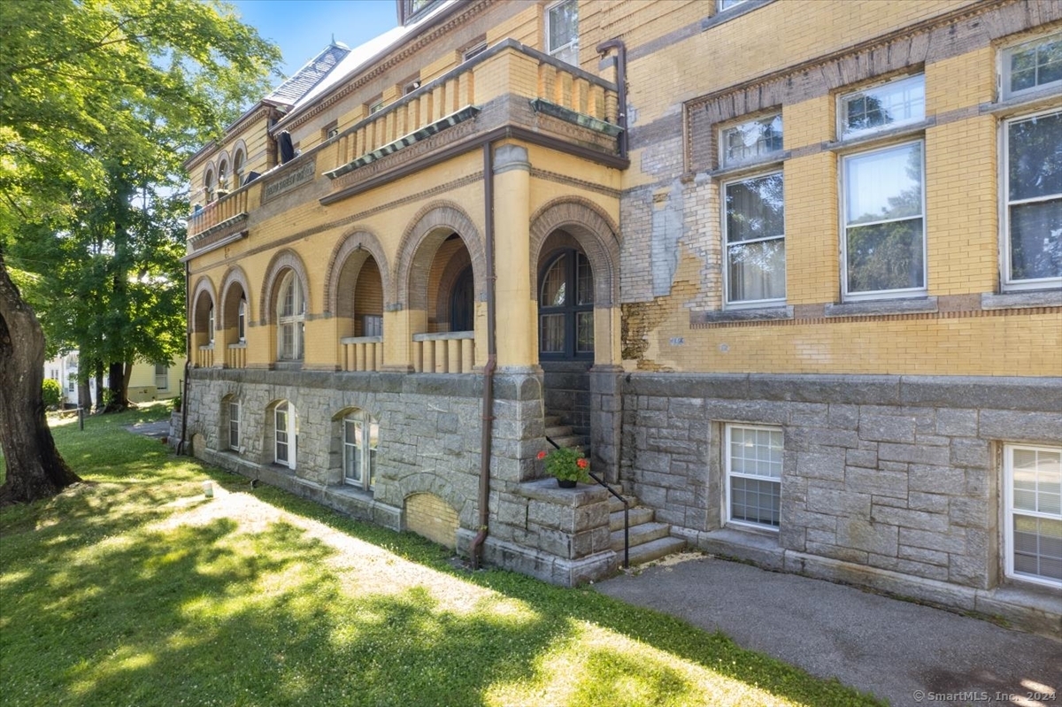 Opportunity awaits! Historic Broad Street School - Great starter, investment, or 2nd home located in the Chelsea Parade Historic District, just North of Downtown. This Romanesque-style condo features high ceilings, abundant natural light, and plenty of storage. The shot-gun style layout is functional and welcoming, located on the 1st floor, up a half flight of stairs. Although adding a private washer and dryer presents an opportunity, the seller has enjoyed the convenience of a shared communal laundry, down the hall. The full bath features a tub with a shower, as well as, a brand-new floor. The bedroom is comfortable with wall-to-wall carpet, and practical, with a built-in desk nook. The aggressive pricing accounts for necessary appliance upgrades and costs to repair/replace the heat pump; although, masonry materials tend to keep the temperature cool. Private parking is available for owners and guests, behind the building off Rockwell St. Conveniently located minutes away from Backus Hospital, NFA, Mohegan Park, shopping, highways, transportation, Casinos, and more! Schedule your tour now, to see for yourself, all this transformed historic school has to offer! A special assessment is in the final stages to complete necessary exterior maintenance and repairs. Cash or conventional works best. Seller to do no repairs or credits, property is priced accordingly.