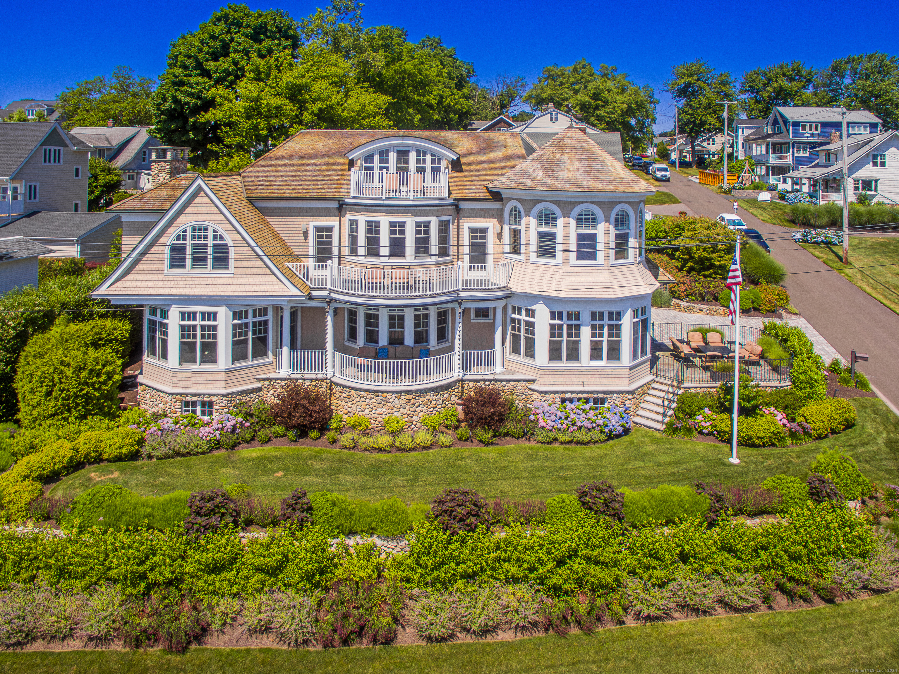 Welcome to 65 Morningside Drive! Luxurious Waterfront Living in the sought-after Morningside Association, with splendid vistas across the glorious Long Island Sound. Breathtaking elegance abounds in this custom-built Colonial, offering a beautiful blend of quality craftmanship and architectural design. Be captivated as you enter the inviting foyer with its dramatic winding staircase and magnificently high ceilings, each room masterfully highlighting the picturesque water views. The living room and formal dining room are perfect for hosting large gatherings. The awe-inspiring gourmet kitchen features state-of-the-art appliances, including a Wolf double oven, Sub Zero refrigerator and freezer, two dishwashers, wet bar, and a delightful breakfast area. Retreat into the wood-paneled study and cozy family room. Relax in the primary ensuite featuring a domed ceiling, his & her walk-in closets, a luxurious bathroom complete with jacuzzi tub and walk-in shower, and a sitting room with a second balcony overlooking the Sound. In addition to three guest bedrooms and 5 bathrooms, retire to the third-floor loft for private views off of top deck. NO FLOOD INSURANCE NEEDED!