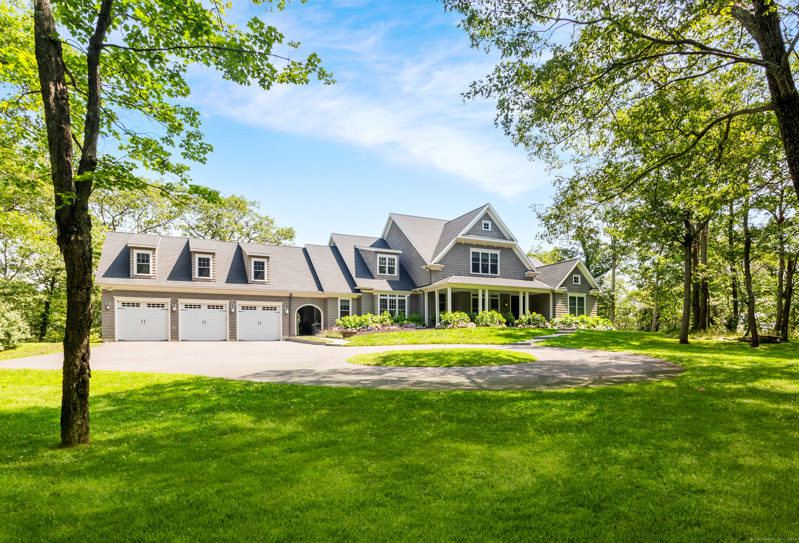 Welcome to the epitome of bucolic living in this unparalleled Southern Sherman estate nestled within the Wakeman Farms subdivision of custom-built homes just under a mile from the NY line. Step into luxury with this exquisite residence perfectly positioned on over 9 acres of lush landscape adorned with vibrant hydrangeas and mature trees. Designed for sophisticated yet comfortable living, this home boasts a meticulously planned layout, balancing everyday functionality with refined architectural details. The chef's kitchen with pantry overlooking the great room, eat-in area and formal dining room, is perfect for cooking and entertaining. A versatile den/keeping room adds to the main level's charm, which also includes a primary suite with walk-in closet, laundry, and powder room. The upper level hosts 3 spacious bedrooms and 2 full bathrooms, ensuring ample space for family and guests. Modern conveniences abound with 4-zone hydro air heating, porcelain tile radiant heated floors, a 50-year roof, Anderson windows and doors, SMART recessed lighting and motorized shades. A tech hub ensures seamless connectivity, while a breezeway leads to a generous 3-car garage with an unfinished bonus and media room plumbed for future expansion above.