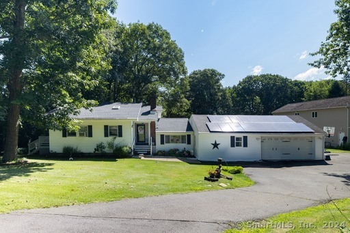 This beautifully updated 2, 200+ sq. ft. Ranch offers incredible versatility, perfect for multi-generational living or accommodating in-laws. With 4-5 bedrooms and 3 full bathrooms, this home caters to a variety of needs. The unique layout of this home ensures privacy and comfort for all occupants. The modern kitchen features elegant quartz countertops, a breakfast bar, and recessed lighting. The main level also includes a dining room with sliders leading to a wrap-around deck, two bedrooms, hardwood flooring and two full bathrooms. A few steps down, you'll find a stunning living room with a fireplace, a spacious primary suite with a sitting area and full bathroom, and French doors leading to a deck. The remainder of the lower level includes a cozy family room and an additional 1-2 bedrooms. There's also a utility room with laundry facilities and mechanicals. The property boasts a circular driveway leading to a heated 2-car garage with 220 wiring. The backyard featurs an above-ground swimming pool for added enjoyment, while the natural beauty of the forest allows for privacy. Additionally, the home is equipped with economical solar panels to help reduce electric costs. This home was designed with privacy in mind and will delight you!