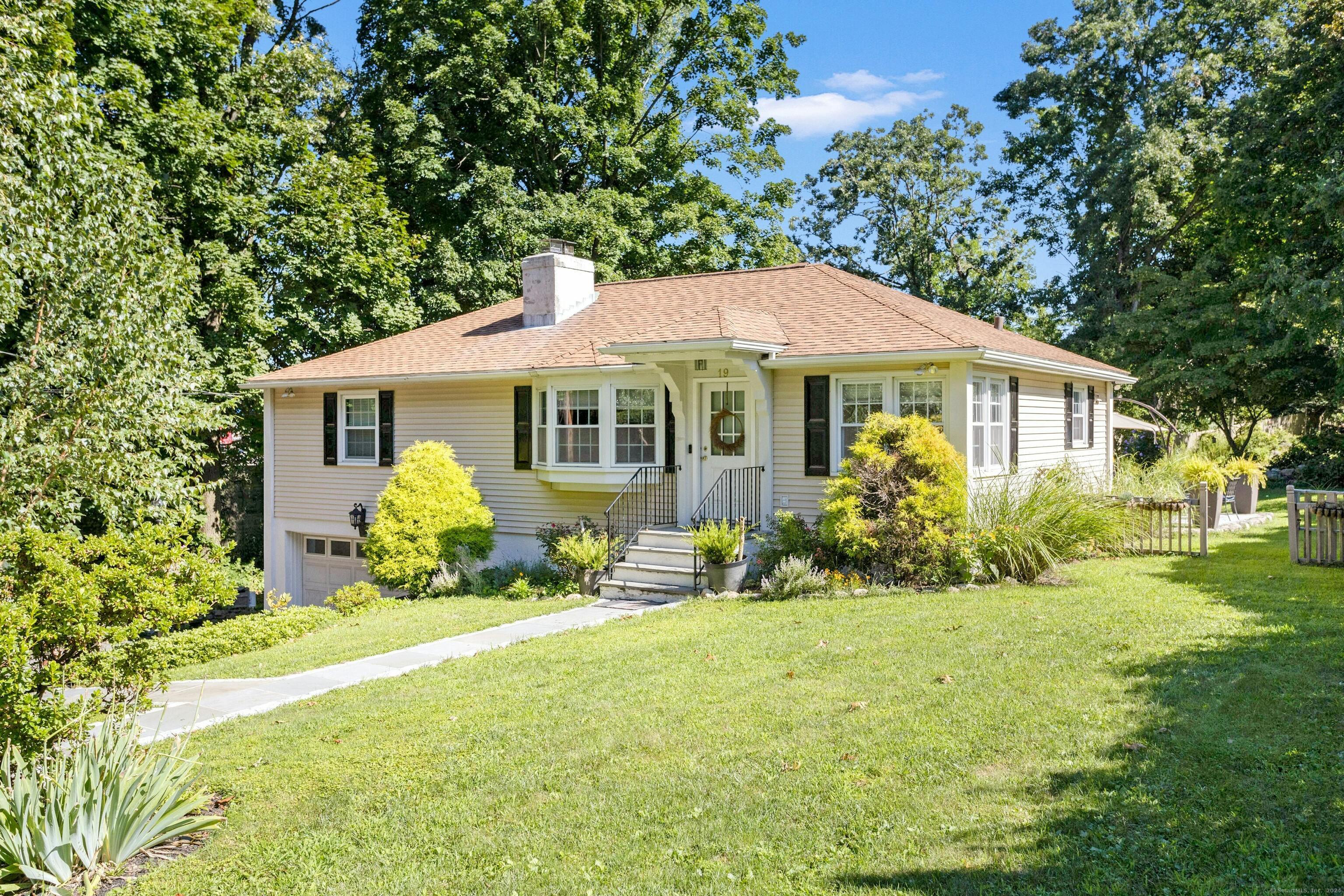 This sun-filled, meticulously maintained, 3 Bedroom Ranch Home boasts an open concept living/dining area with a wood-burning fireplace and breakfast bar into a cook's kitchen. A private home office, three generous bedrooms and a full bath complete the entry floor. A large finished lower level with a full bath, laundry room and garage entrance is flex space with tons of storage. Walk to the Noroton train and Darien Commons. The large side and back yard with a stone terrace are great for entertaining or relaxing. Attached, oversized, 1.5 Car Garage and central air conditioning and energy efficient windows complete this terrific Darien offering.