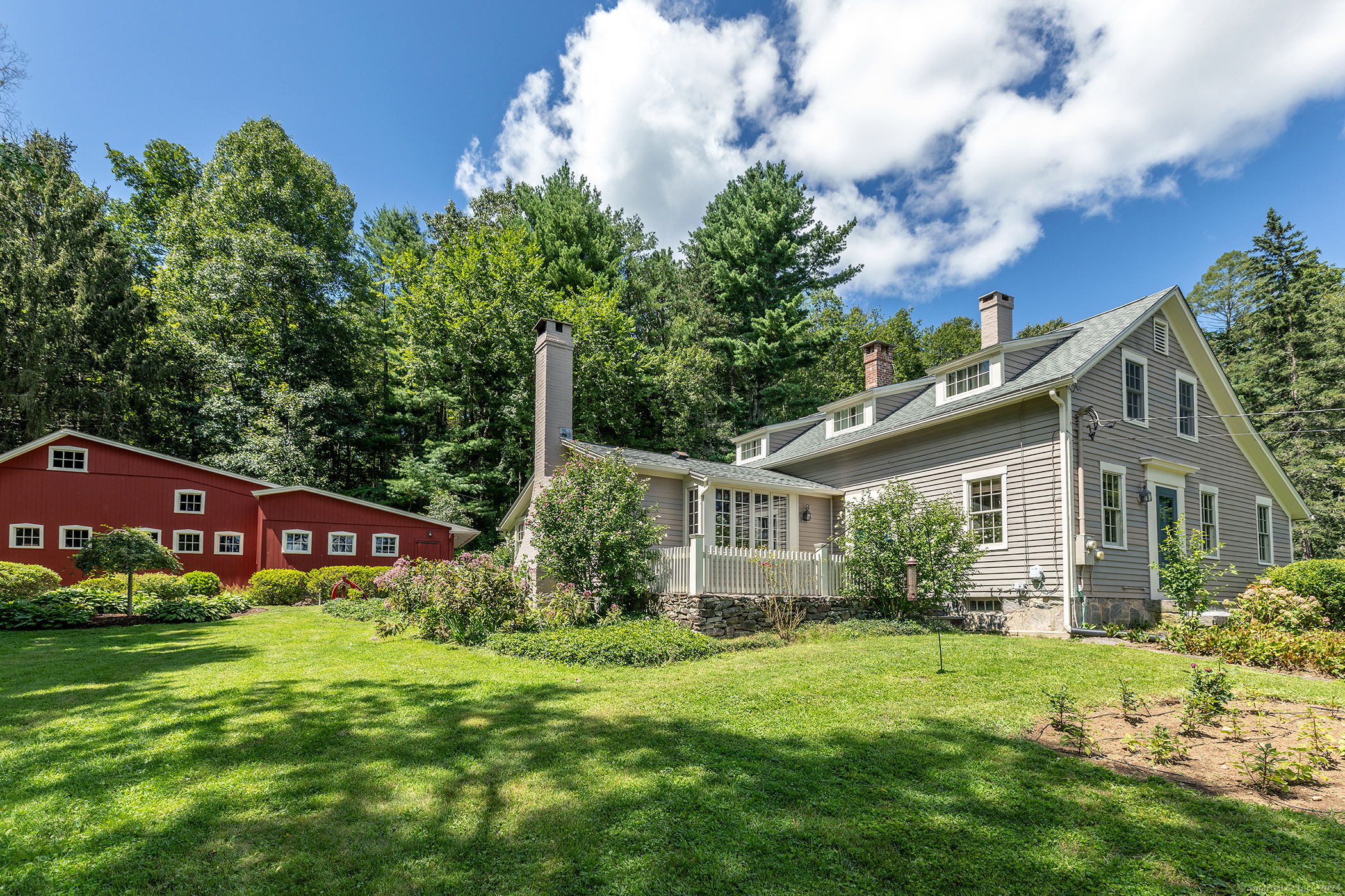 A rare find, this ca 1860 cape sits on 2+ acres just outside of town and includes a cottage, in-ground pool, pool cabana, workshop, and potting shed. The home itself is the perfect size with three bedrooms and two full and one-half baths. The living room is highlighted by built-ins and exposed beams. The dining room with exposed beams has corner cupboard and French door to a stone terrace perfect for al fresco dining or a morning coffee. A fireplace adorns the eat-in kitchen and there is a 5-burner gas stove top, Bosch double oven and Subzero refrigerator. The primary bedroom is conveniently located on the main level and has a vaulted ceiling, spacious full bath and French door to rear patio. Upstairs you'll find the two other bedrooms, a full bath and foyer perfect for a reading nook or office area. The main level also includes a foyer, mudroom and laundry room. Beautiful hardwood floors throughout the home. The many updates include a generator (services house & cottage) and smart systems for thermostat and security. The grounds are lovely with mature perennial gardens, multiple patios, stonewalls and walkways, and a fenced in raised bed vegetable garden. There is a detached two bay garage and a detached 1 bay stone garage. The lovely 768 sq ft cottage is set away from the main residence & has kitchen, living/dining combo, two bedrooms, full bath on main level and lower level with half bath and laundry room. List of upgrades/updates available.