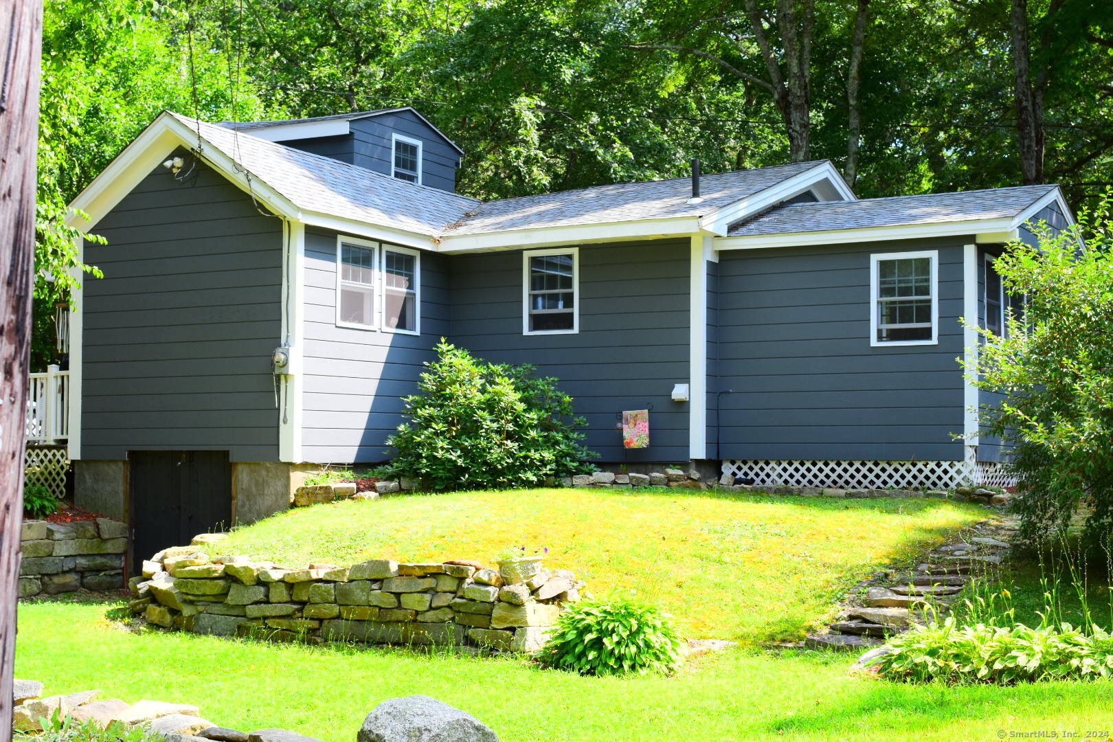 Looking for a completely remodeled retreat on Little Pond? This is it! This home was taken down to the studs and rebuilt in 2020. New roof, windows, heating system, water heater, holding tank, floors, kitchen/bath, deck, and one car garage. Plus, exterior repainted 2024. Move right in! Gray bamboo floors throughout. Soft close kitchen cabinets, and granite counters. Vaulted ceilings help make it open and airy. Massive bathroom with washer/dryer. Primary bedroom with generously sized walk in. Enclosed porch adds an additional 120 sf of seasonal living space and has water views. Cute loft area for hanging out. 24x12 ft garage. Composite deck/patio area with hot tub surrounded by perennial flowers. This property consists of multiple lots which gives you plenty of room to expand or potentially build a separate accessory dwelling. See information in attachments. An hour and a half to Boston, only 20 mins to Worcester, and 45 minutes to Providence.