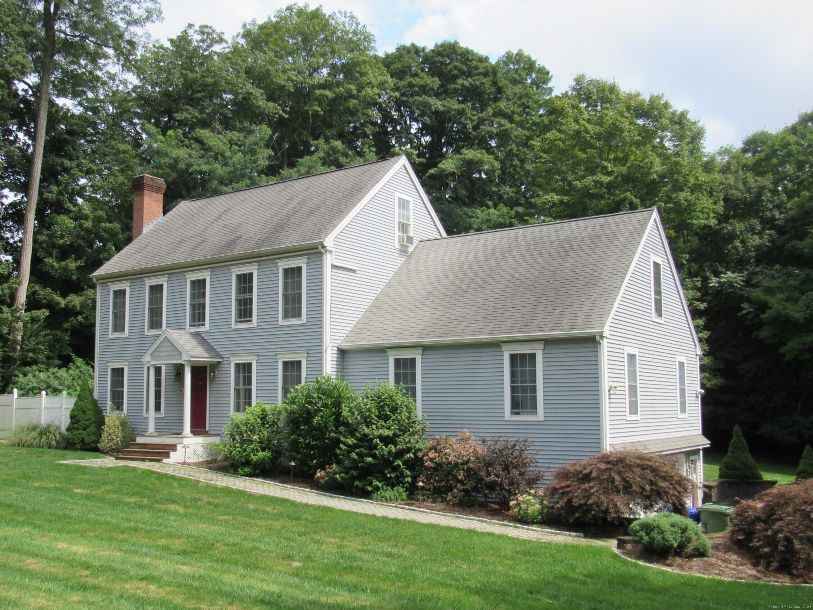 Lovely Colonial Home with Fabulous 2 Story In-law suite with private entrance. The main part of the home is highlighted with gleaming hardwood floors and both a finished great room in the attic and a spacious family room in the lower level. The kitchen features granite countertops and cherry cabinets while the front to back living room as a pretty fireplace and opens to a private deck overlooking the backyard. 3 generous size bedrooms are on the second floor with the potential for more bedrooms in the finished attic or the in-law side of the home. Extra amenities in this home are: irrigation system, solar panels, leased generator, storage shed, roomy paved driveway, front stone paver walkway, oversized garage with EV charging station, security cameras, built in safe and so much more.