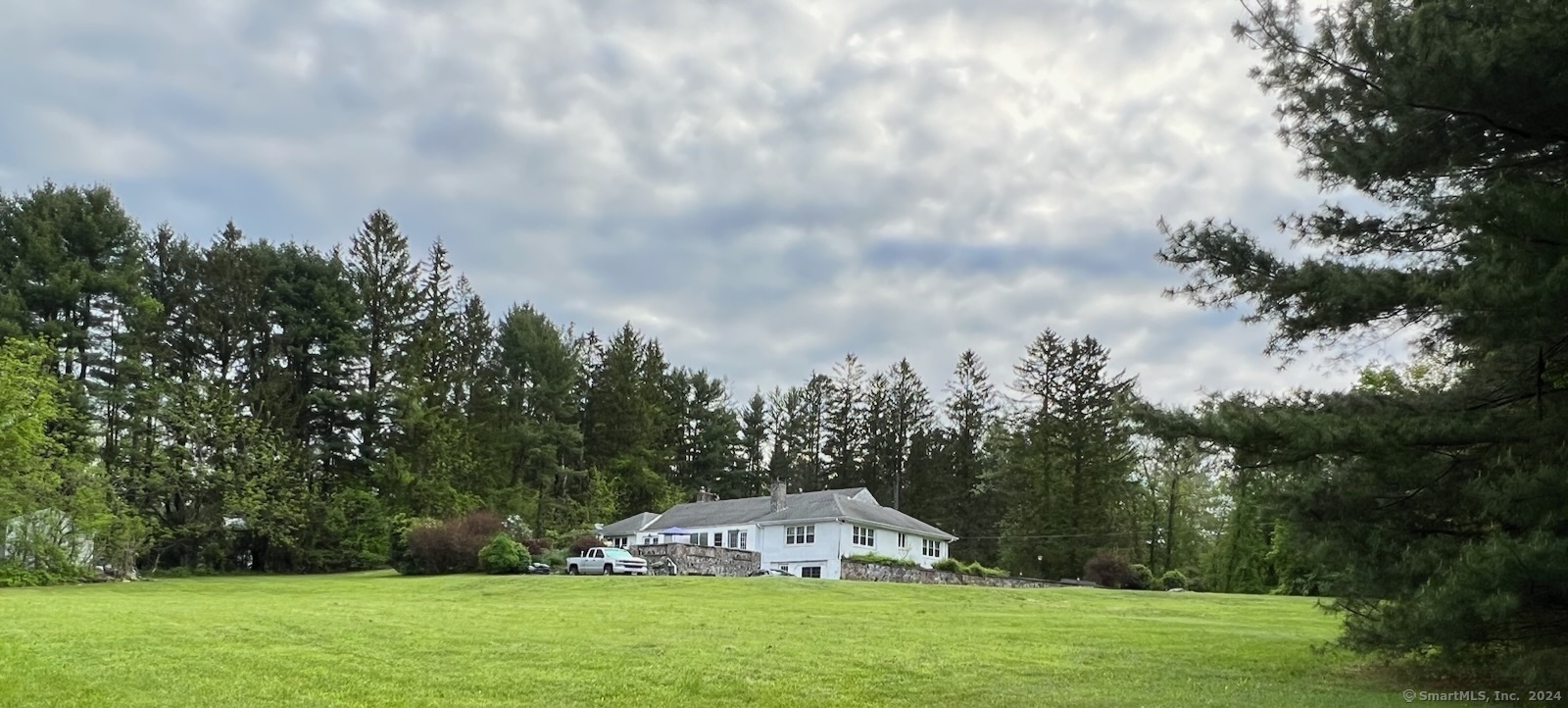 This expansive, one-of-its-kind brick 4-bedroom 4-bath ranch home set on over 2 acres promotes true one level living and space that can utilized in many, many different ways. Enjoy the extensive formal New England style stone walls , garden views from the stone deck and chill in sprawling level yard. The entryway offers space, calm and comfort as you proceed to the fresh eat-in kitchen with ample cabinets, French doors. The sun-filled formal dining room with hardwood floors flows to the formal living room with picture window and fireplace making it great for hosting and entertaining. The living room's French doors open to the sunrooms for you and your guest to bask. Don't get lost as your discover the generous-sized bedrooms and 3 baths on the main level. It doesn't stop there as the lower level is completely finished with additional bedrooms, full bath, galley style kitchen, and walk out entrance making it ideal for In-law apt or additional living space . Laundry located on the main floor and in the finished basement provides options and convenience. The enormous and open finished attic provides various options and is awaiting your personal touch. This home also features a two car attached garage for your vehicles or storage. Don't miss the opportunity to make this dream home your own!