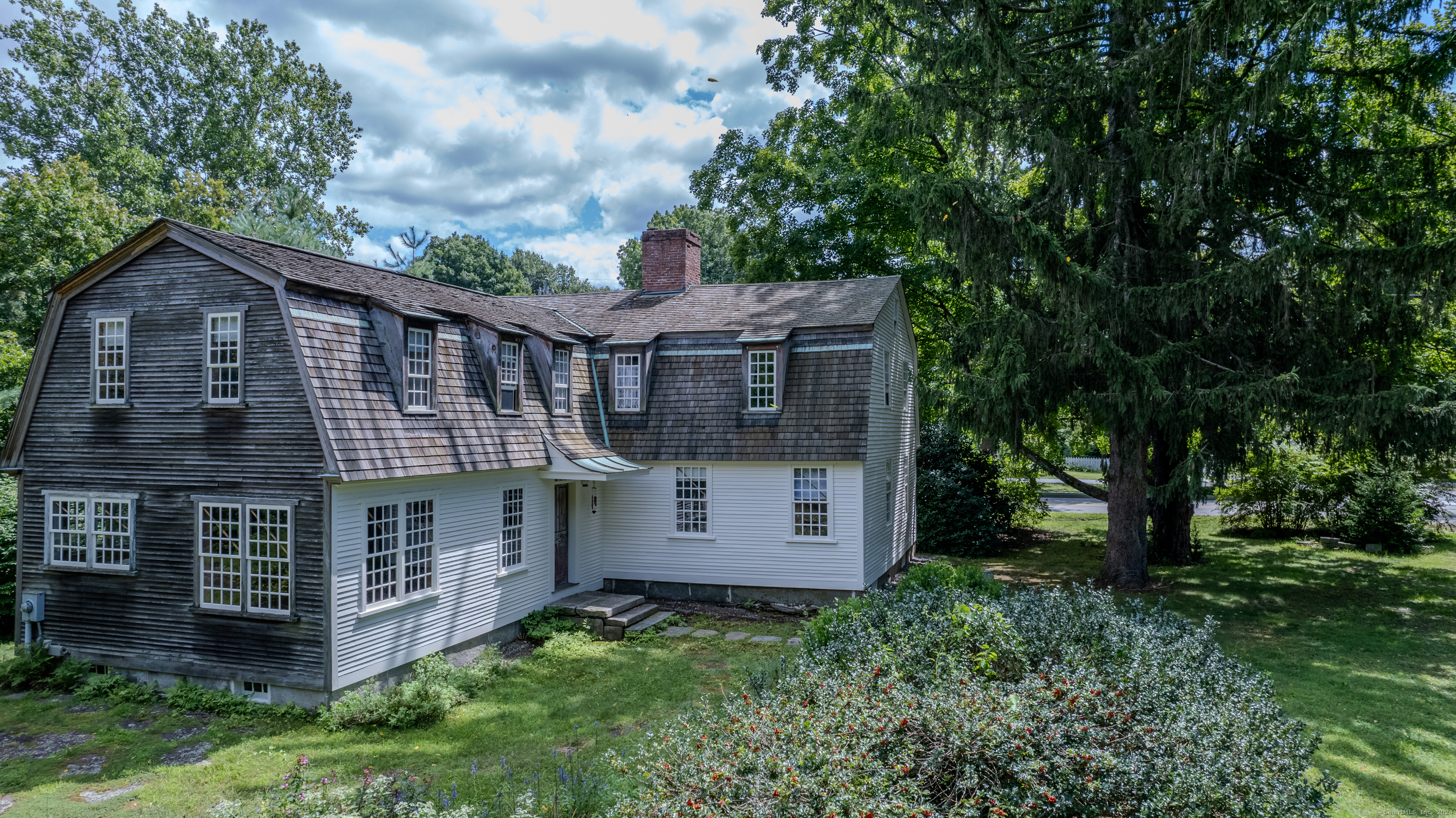 Imagine calling home a piece of American history that seamlessly blends timeless elegance with modern comfort. This 1760 antique home offers you a rare opportunity to immerse yourself in a living masterpiece where every detail tells a story. Admire the classic timber-frame construction and wooden siding, enhanced by a steeply pitched roof and small, multi-paned windows. The solid wooden front door welcomes you into a space where every room tells a story. Inside, wide wood plank floors and three grand fireplaces with ornate wooden mantels create a warm, inviting atmosphere. Distressed wooden doors add character and authenticity, making every detail a historical delight. This home is more than just a historical gem-it's also a haven of modern comfort. With central air and a three-zoned heating and cooling system, you can enjoy the perfect temperature year-round without sacrificing the home's antique allure. The layout is thoughtfully preserved, offering a central hall, formal parlor, and formal dining room that reflect the elegance of its era while accommodating today's lifestyle.  This home is more than a residence; it is a work of art and a testament to true craftsmanship. It embodies both the soul of a home and the refined features of a beautifully preserved artifact, offering an exceptional blend of past and present that is perfect for those who cherish history and quality living. 219 Hubbard Ave is ready to be called home once more.