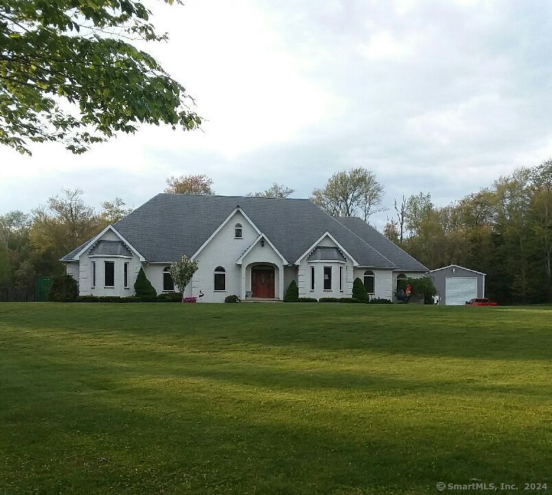 Welcome to this stunning contemporary ranch, a true sanctuary on 17+ private acres. This sprawling custom built home is a harmonious blend of modern luxury & natural beauty. This home features geothermal heat, for energy efficiency, with back up oil fired furnace, radiant heat tile floors, 9' ceilings, & Marvin windows. The primary suite opens up to the back patio, has a massive en suite bathroom complete with jetted tub, steam shower, Cherry cabinets, and gorgeous walk in closet. Two additional bedrooms, one with its own full bath and walk in closet, & study that could easily be turned into a 4th bedroom. The grand dining room features French doors and can easily accommodate a table for 12. Enjoy cooking and baking in equally grand kitchen w/cherry cabinets, granite counters, a pantry, and stainless appliances. Vaulted ceilings with remote controled skylights, a wall of windows looking out to the backyard fill the living room with an abundance of light. The exterior of the home is made up of imported granite & aggregate bricks that sparkle in the sun, limestone sills and steps, and vinyl. Relax by your 20x40 in-ground heated pool. For the car enthusiast, there's a 20x40 attached garage with radiant heat floors, a 24x30 outbuilding with 14' high door, & an additional under house garage that can hold 5+ cars! 15, 000kw Generac whole house generator provides peace of mind when the power is out. This property is the perfect retreat for those seeking tranquility & sophistication.