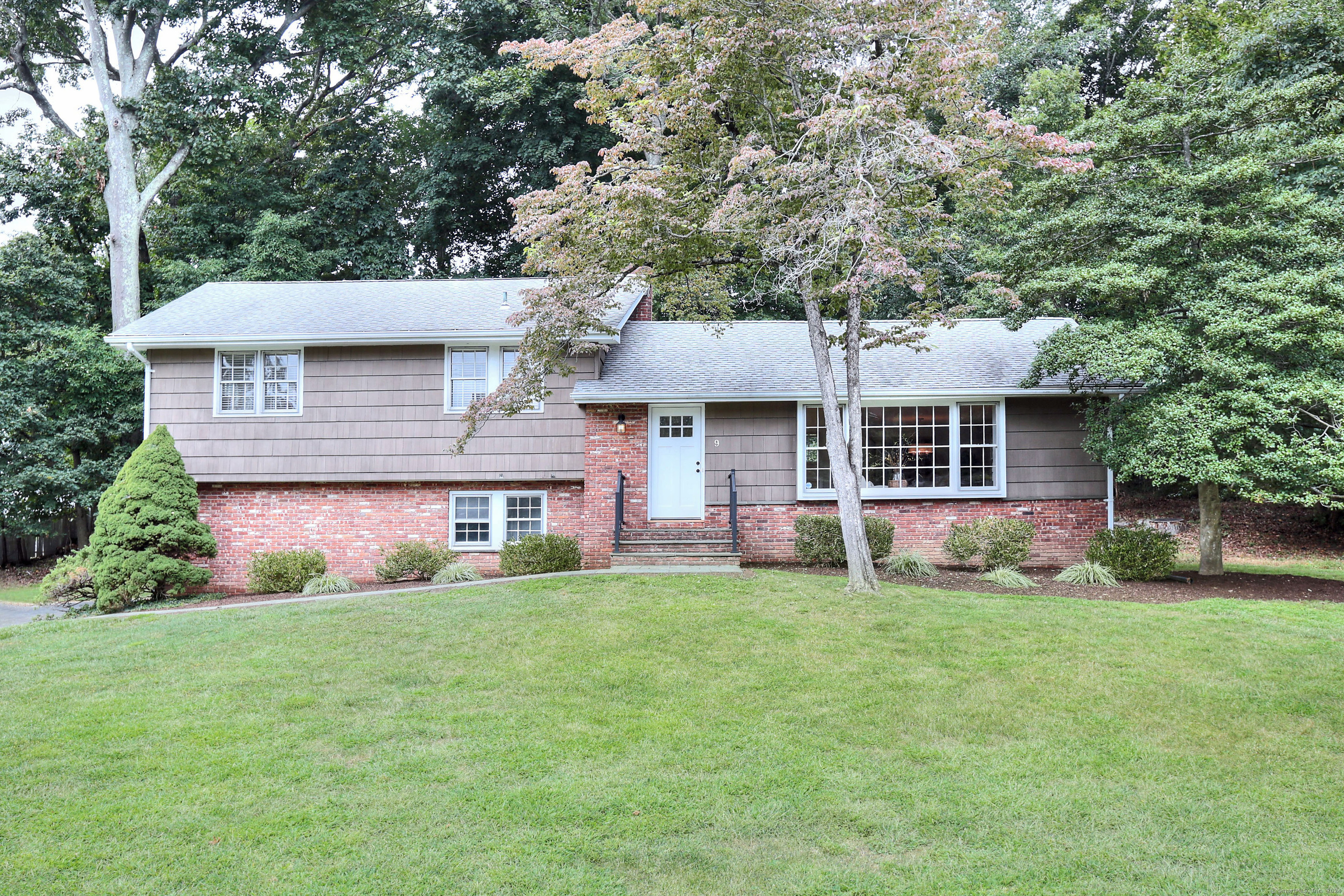 This charming Contemporary/Split-level house is located in the desirable Compo South neighborhood of Westport, set on a 0.61-acre lot with 2,015 square feet of living space. The beautifully landscaped exterior maximizes space and leads to light-filled, bright rooms inside. The living area flows seamlessly outdoors, creating a smooth open layout for gatherings. The kitchen has an ample counter and cabinet space, along with appliances. This light, bright, and happy home features four generously sized bedrooms, a walk-out lower-level family room with a fireplace, and a sitting room, making it easy to fall in love with. The incredible primary bedroom features a spacious walk-in closet on the first floor and large windows that fill the room with natural light, creating a calm and comfortable retreat. Close to the beach, the train station, Longshore, and all Westport amenities. Don't miss your chance to make this wonderful home your own!