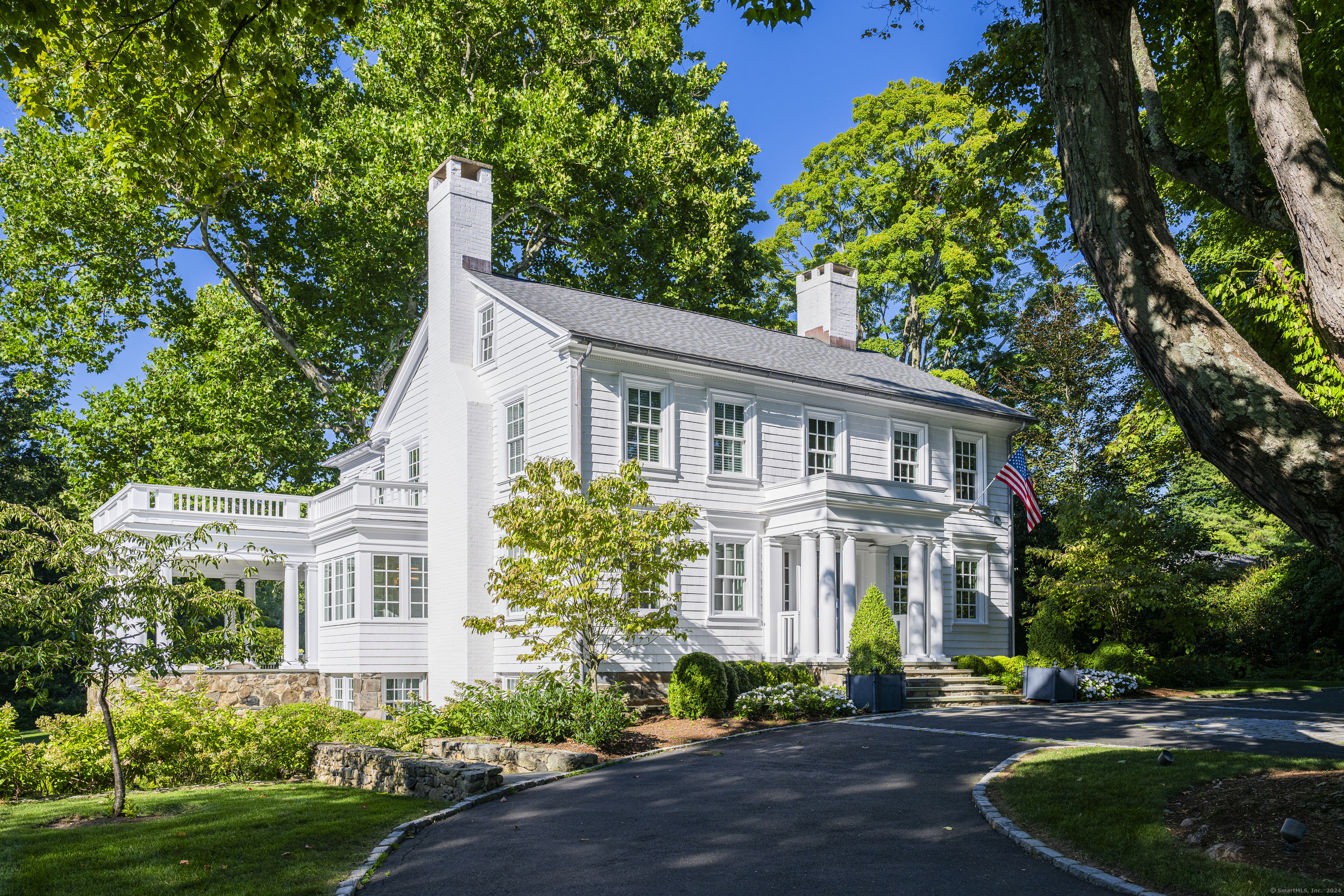 Welcome to 183 West Road, a stunningly beautiful and meticulously restored antique Colonial situated on a picturesque 3.68-acre corner lot, just a mile from New Canaan's town center. The home combines timeless architectural charm with modern luxury, creating a serene retreat. Completely renovated by a renowned interior designer, the residence preserves its historical integrity while offering today's conveniences, resulting in a home that is both captivating and functional. The main residence features five ensuite bedrooms, four fireplaces, and four finished levels with meticulous custom detailing throughout. Step outside and you'll find a heated in-ground swimming pool and spa, complemented by a state-of-the-art pool house that looks likes it's straight out of a magazine. The sprawling property features multiple outdoor entertaining spaces, formal gardens, and expansive bluestone terraces designed for seamless indoor-outdoor living. A charming separate guest cottage features cathedral ceilings in both the bedroom and great room, a kitchen, bath and fireplace. The finished barn with loft and cozy outdoor fire pit further enhance the estate. Centuries-old maple trees and graceful sycamores add to the property's majestic charm. 183 West Road is a one-of-a-kind property where history, luxury, and tranquility meet.