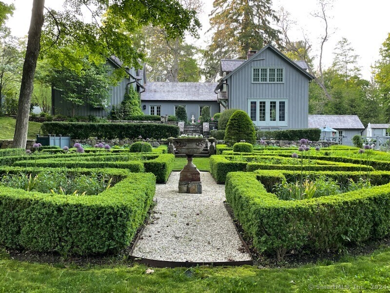 Welcome to the Sanctuary! Discover a slice of Europe in the heart of Ridgefield with this charming 1760 converted barn. Originally transformed by antique dealers in 1950 as a cozy weekend retreat, this historic barn, with its original wide plank chestnut floors, was once part of a neighboring home for over two centuries. In 2000, the owners enhanced the property with a formal English garden, designed by Schoeller Ruzicka Design in a classic Gothic style. The garden bursts with color from phlox, daffodils, roses, and daisies, complemented by fountains, a spa, a stone archway, and a tranquil pond that feeds into the Titicus River. Recent owners have made thoughtful additions, including a garage, mudroom, expansive studio, and a unique passage leading to the entry courtyard. Modern updates, such as a cedar roof, whole-house generator, remodeled bathroom, split system heating and cooling, irrigation, and upgraded electrical systems, bring contemporary comfort to this historic gem. Located just 60 minutes from New York City, The Sanctuary provides an idyllic weekend getaway or a perfect year-round home to enjoy the best of Ridgefield's rich history and natural beauty.