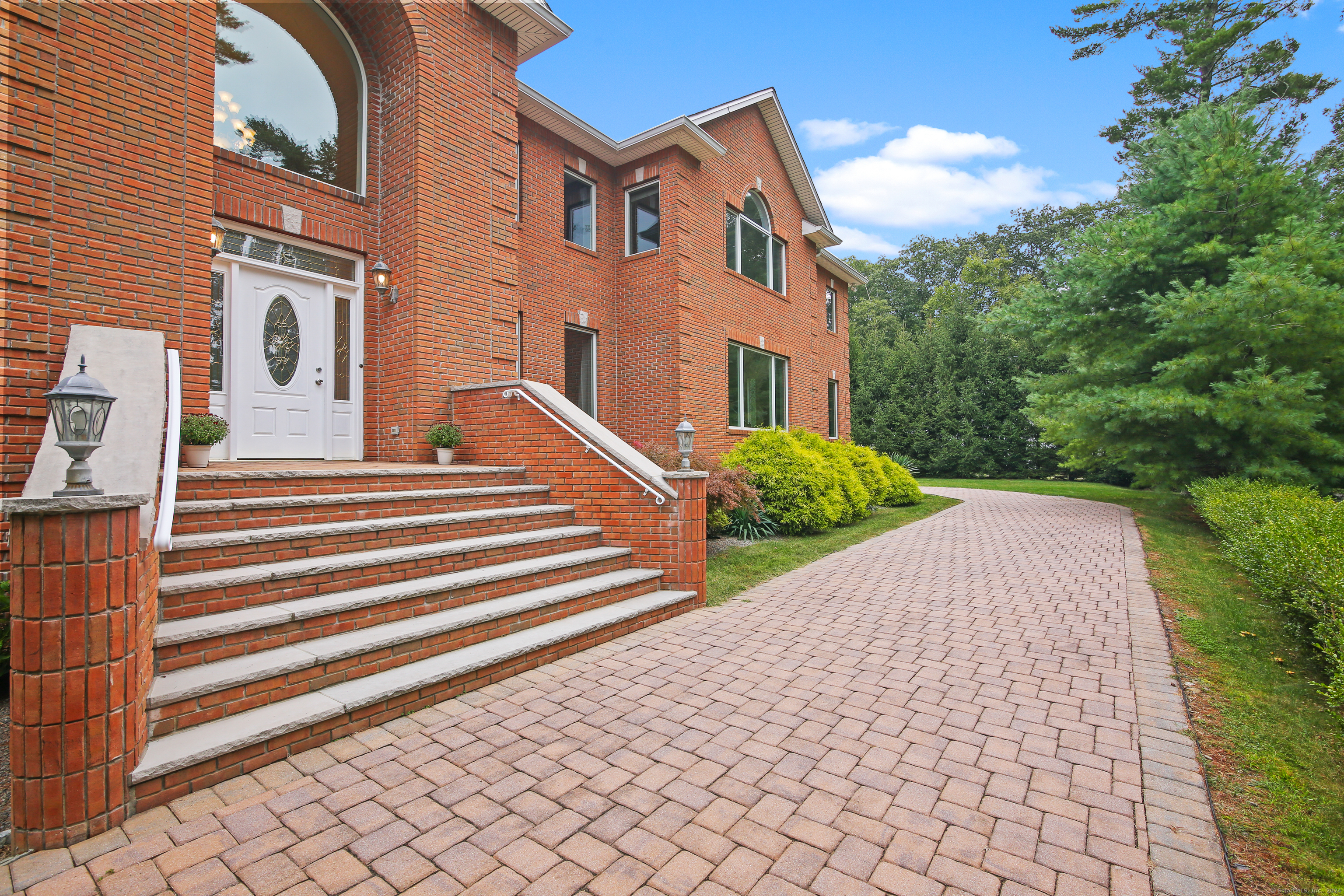 This European Style luxurious custom-built colonial home located in desirable North Stamford is close to the Merritt Parkway, minutes to downtown and only 45 minutes to NYC. This thoughtfully designed 5, 053 sf home has mature privacy landscaping, city water, a separate two-level in-law/aux pair wing w/ kitchenette, bathroom and separate staircase, perfect for multi-functional living or recreation purposes. Factory finished hdwd flrs, 9+ ft ceilings, oversized Pella windows, and crown moldings are found throughout this gorgeous 4+ bdrm, 7 bath home. The main floor entry boasts a 2-story sweeping circular staircase & Murano chandelier w/lift. Flowing from the foyer are the elegant Living room, Dining room, Family room with 2-story natural stone fireplace, Office, stylish solid cherry gourmet chef's EIK w/high-end appliances, breakfast area w/slider leading to a patio and access to a mudroom, spacious laundry room plus 3-car garage. UL primary en-suite boasts luxurious onyx bath, jacuzzi tub, spa shower, bidet, a cathedral ceiling, Palladian window, mini bar, walk-in cedar closet and separate office or exercise room w/sliders to a private balcony. Down the hall are 3 add'l bdrms, one with a finely appointed en-suite and a hall bath. A 2, 000 gal. sceptic tank allows for two add'l bdrms. The 2, 755 sf multi windowed unfinished w/o LL has a full bath & fireplace. The bonus room above 3 car garage can also be converted to add'l living space. See attachments for many more features.