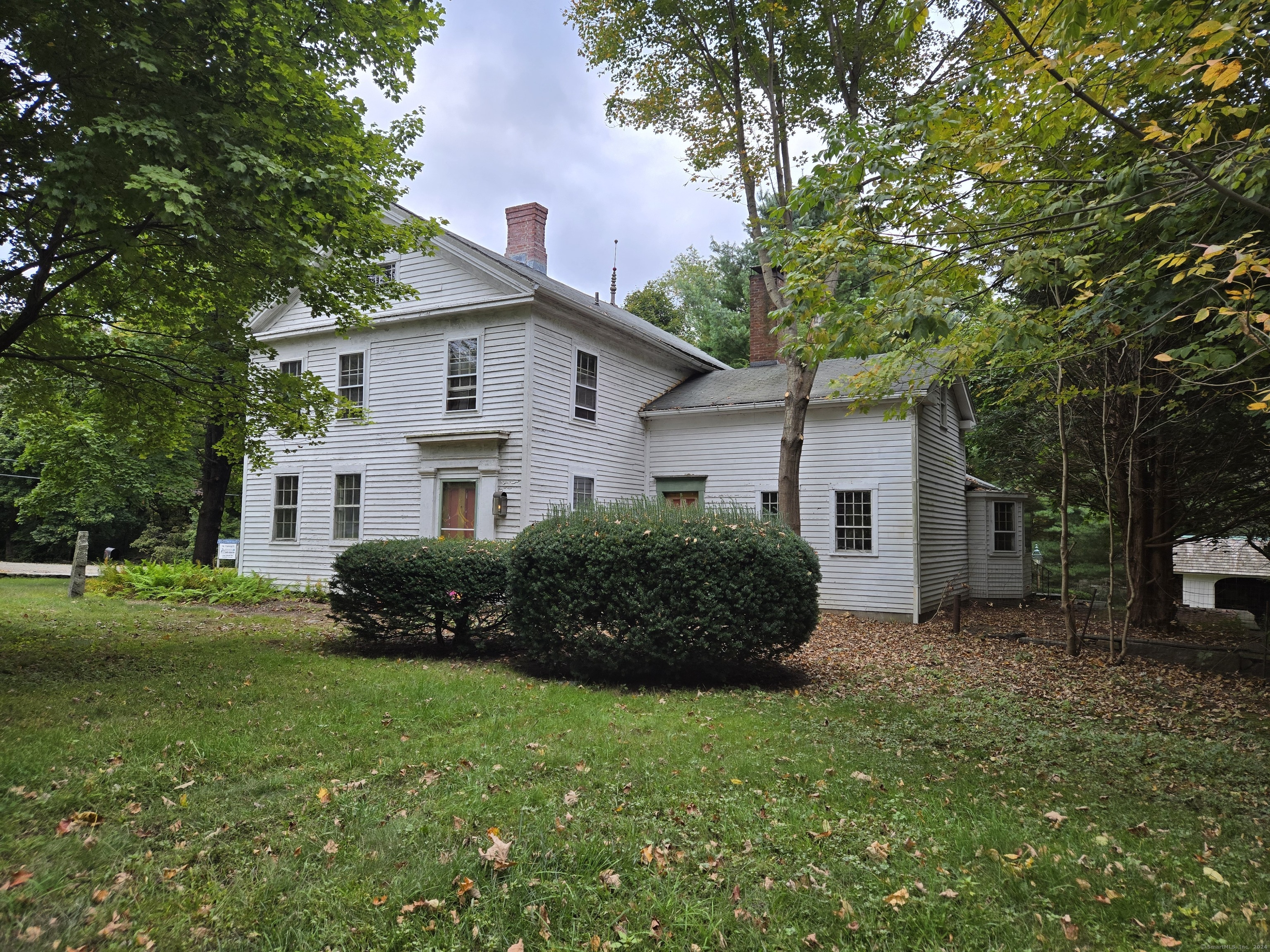 Discover your very own piece of history in the heart of Bethlehem! This charming vintage home boasts five fireplaces, wideboard flooring, exposed beams, and a host of other delightful features, all just a two-minute stroll from downtown. Perfect for entrepreneurs, this property provides excellent visibility for an in-home business, along with a spacious workshop ideal for craftsmen looking to create right at home. Enjoy the beauty of stone walls, an open three-car shed, and three additional outbuildings, as well as inviting sidewalks and a cozy back patio. Transform this beautifully vintage residence into your private antique haven!