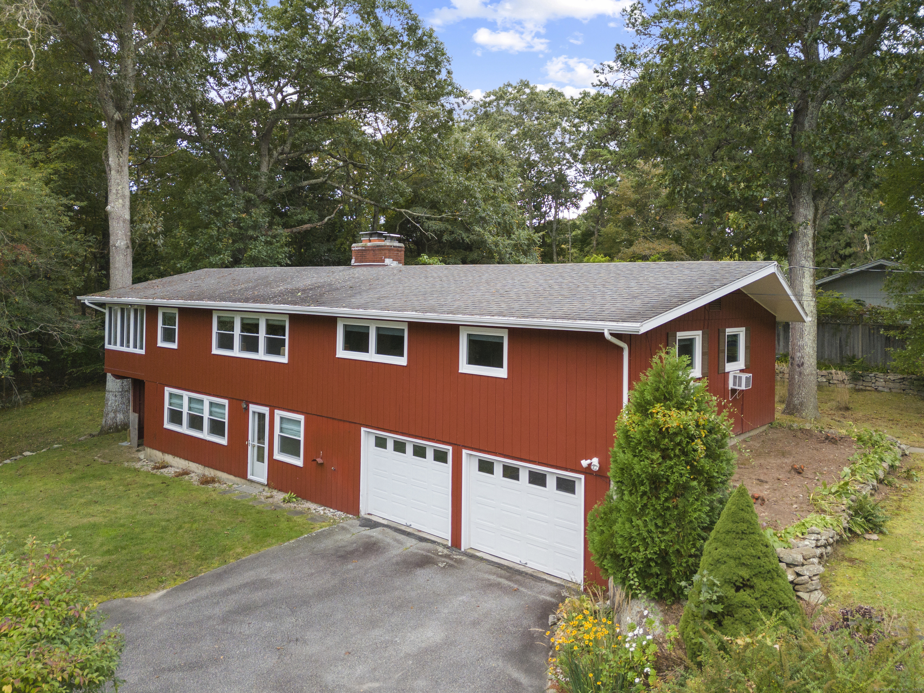 Discover the perfect blend of privacy, elegance, and comfort in this beautifully enhanced embankment ranch, nestled on a serene cul-de-sac. This 2300 sqft home is a gem and just moments away from the conveniences of East Lyme and the charm of downtown Niantic. Pristine wood floors add warmth and character on the main level. The lower level features new luxury vinyl flooring, a large family room with a bank of windows to let the sun shine in. An additional bedroom, 1/2 bath with laundry and easy access to the 2 car garage. In the kitchen enjoy new vinyl flooring, stunning quartz countertops, with a chic tile backsplash. Bask in abundant natural light streaming through brand new windows all adorned with dynamic window treatments. An open floor plan allows for formal dining off the living room and casual fare in the eat in kitchen. Extend your entertaining space with this charming 3 season sun porch. On the main level there are 3 bedrooms and 2 full bathrooms. The primary bedroom has an ensuite. The established yard features garden spaces with shrubs and perennials to enjoy. Whether you're gathering by the fireplace, enjoying the three-season sunroom, or exploring the local community, this home is a place where memories are waiting to be made. Your Laurel Hill Lifestyle Awaits.