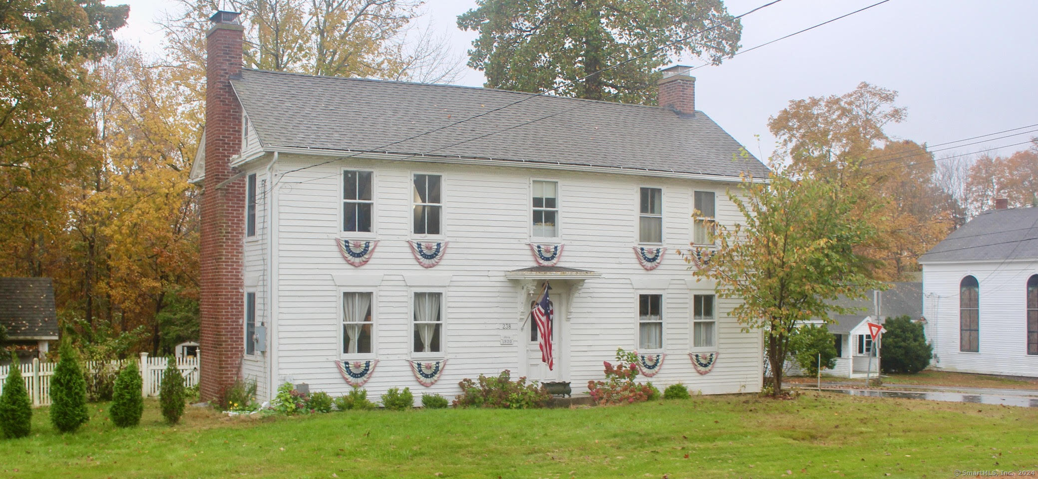 Step into this charming quintessential 1820's New England home known as the Hiram Rider House, blending historic character with modern updates. Situated on a level corner lot across from the town common, with easy access to I 84 & UConn, this home is perfect for a commuter! This home offers 3 working fireplaces for those cold New England winters as well as handcrafted built-ins in the dining room. The home also features beautiful original wide pine flooring throughout, 4 spacious bedrooms w/2.5 baths. The kitchen offers granite countertops as well as a spacious island for entertaining. Need additional storage...this home offers plenty of room with a walk up attic as well as a full basement. Recent updates include septic system, oil tanks and a top of the line Buderus furnace. Outside you'll have plenty of room for gardening and other activities and with a large Kloter Farms shed you'll have plenty of storage. Mud room offers exercise equipment which could come with the home if desired. Come and visit this charming home during Fall in New England!!